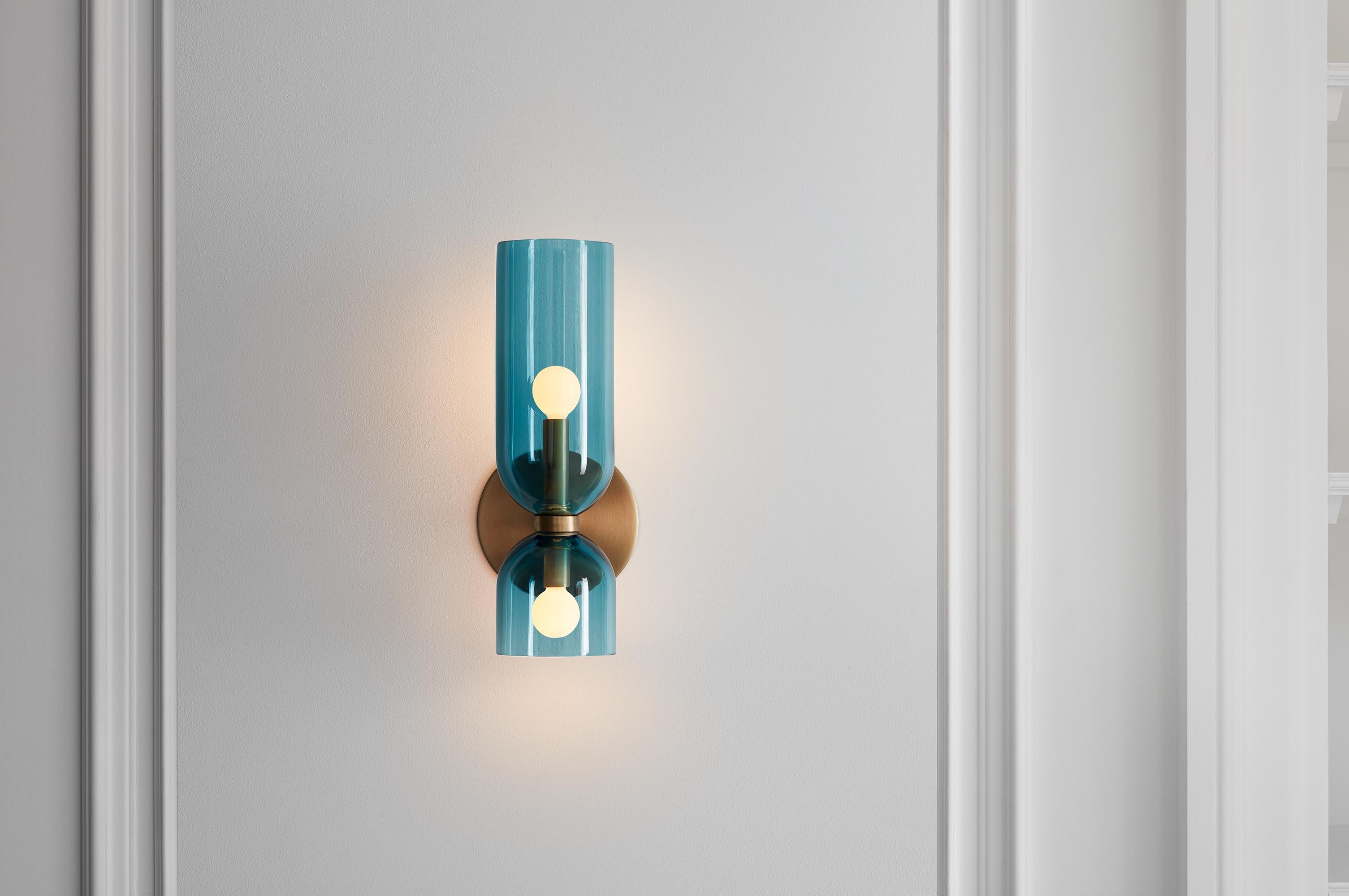 Edie explores the relationship between two similar forms. An exaggerated top column plays against the sconce’s overall sense of quiet restraint.

While Edie evokes a certain feeling of timelessness, it retains a fresh and modern presence.

Opal