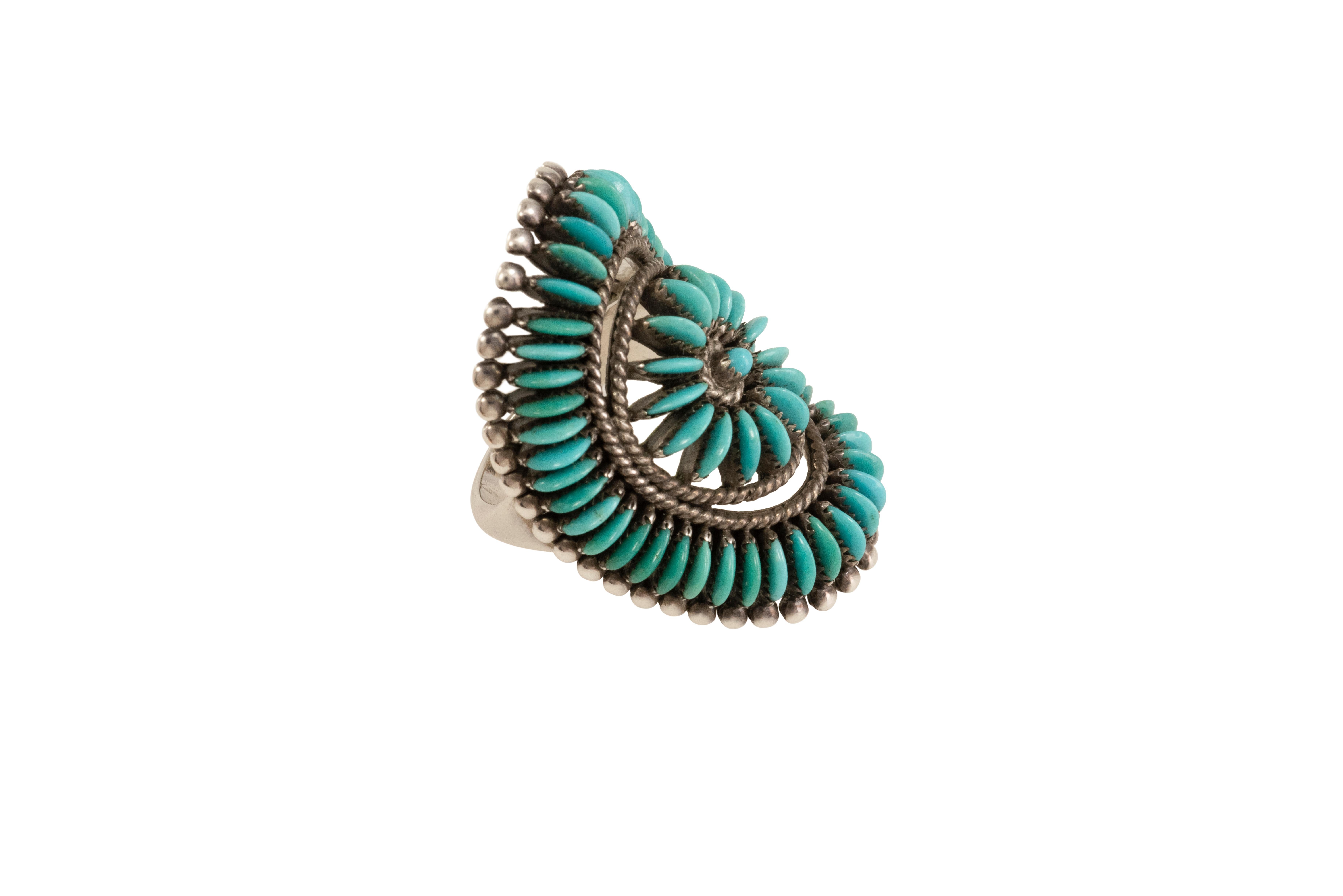 A Lone Mountain turquoise and sterling silver needlepoint ring, by Native American, Zuni,  master artist jeweler Edith Tsabetsaye.  Stamped with maker's mark. 
This ring is a size 6.50 and measures 1.375