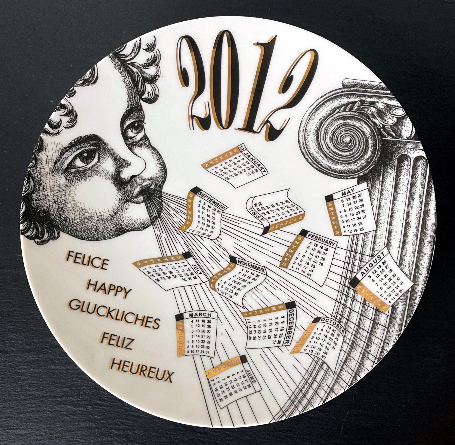 A vintage Italian decorative porcelain plate designed and made by Fornasetti. The commemorative plate is for the year of 2012 and features an angle blowing the calendar pieces. The plate was made in a limited edition of 81 out of 700. The back has