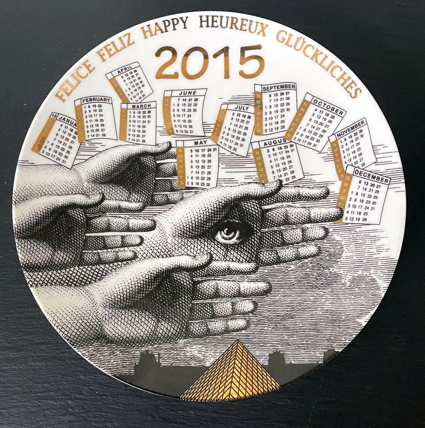 A vintage Italian decorative porcelain plate designed and made by Fornasetti. The commemorative plate is for the year of 2015. The plate was made in a limited edition of 51 out of 700. The back has the pre-drilled looping holes for wall display, and