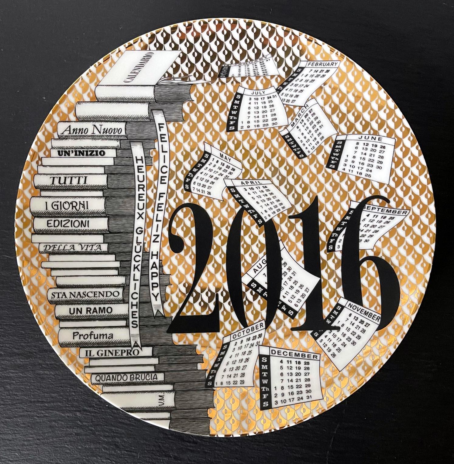 A vintage Italian decorative porcelain plate designed and made by Fornasetti. The commemorative plate is for the year of 2016. The plate was made in a limited edition of 72 out of 700. The back has the pre-drilled looping holes for wall display, and