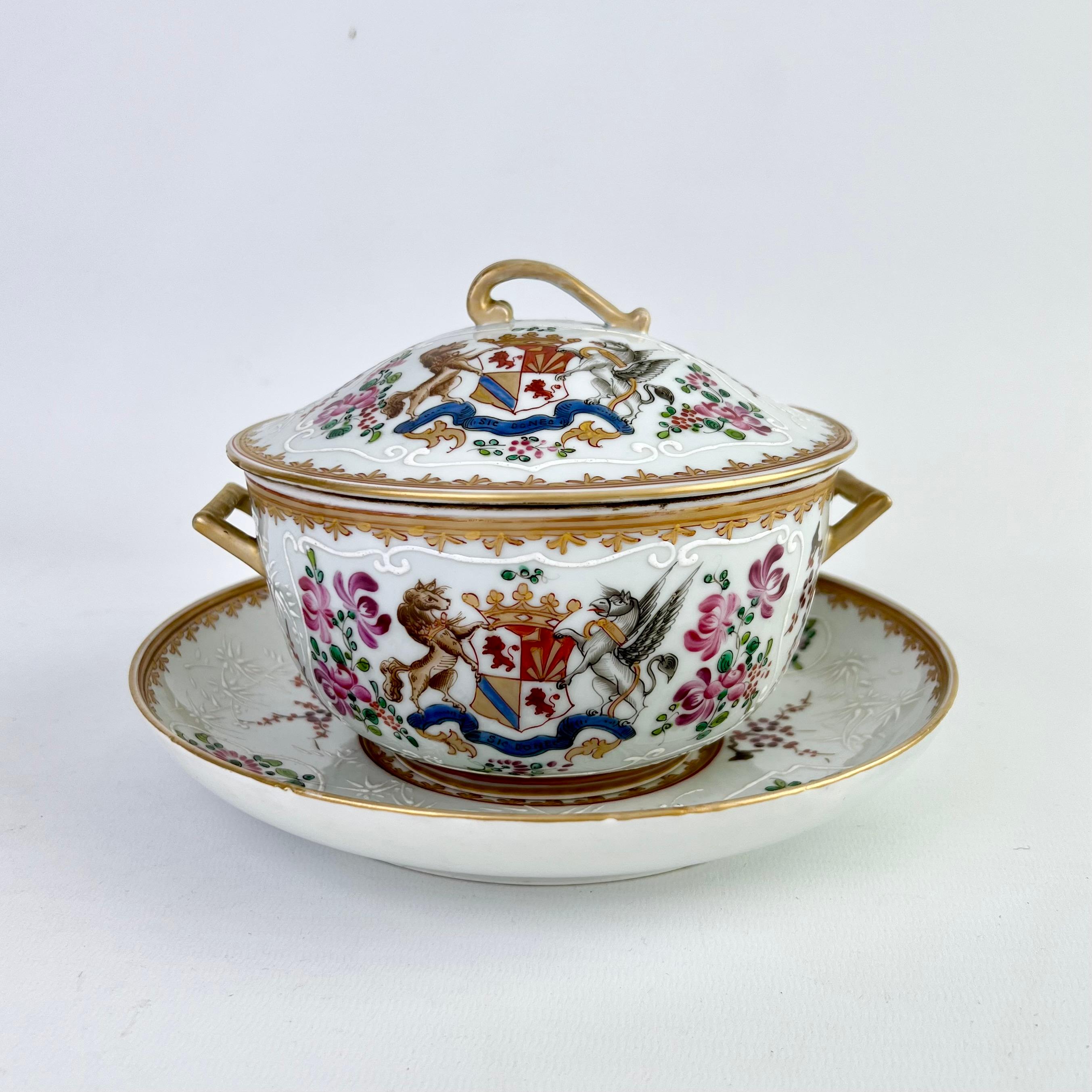 This is a highly decorative armorial sauce tureen with cover and stand made by Edmé Samson in Paris some time between 1845 and 1891. The tureen is made in the Chinese Export style and was probably a replacement for a broken one that formed part of