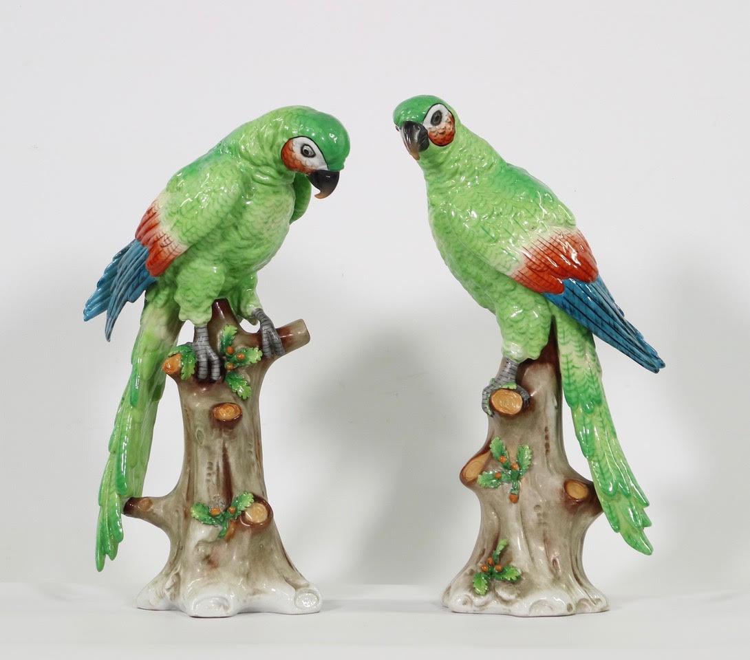 Porcelain parrots by the “Great Imitator” Edme Samson. Features parrots resting atop tree trunks, Marked with imitation Chelsea gold anchor mark as Edme Samson regularly used. The pair are in excellent vintage condition having wear consistent with