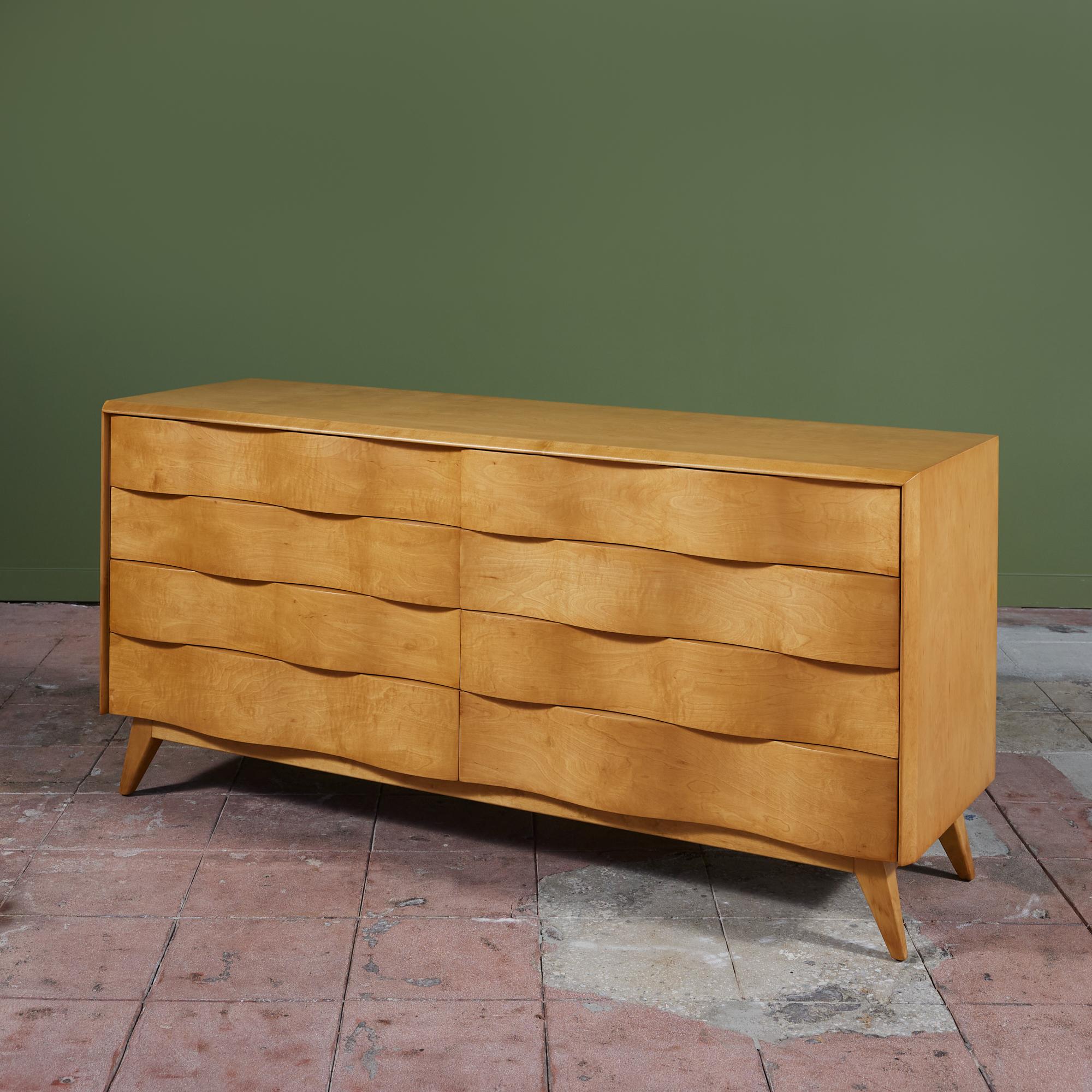 Dresser by Edmond Spence, c.1950s, Sweden. The maple dresser features eight drawers with a unique sculpted wave front design. The dresser rests on 4 splayed legs.

Dimensions
66.25