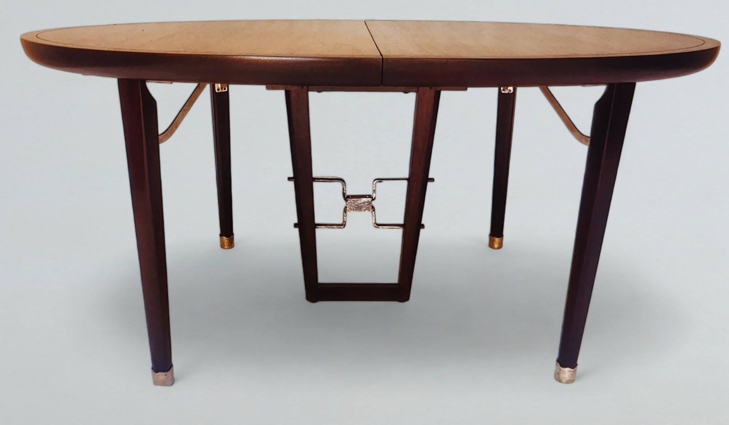 An extraordinary extendable mahogany dining table by Edmund Spence manufactured by Industria Mueblera in Mexico in the 1950s. 
The cast metalwork is gold leafed.
The table has Edmund Spence's Industria Mueblera stamp and additional identification