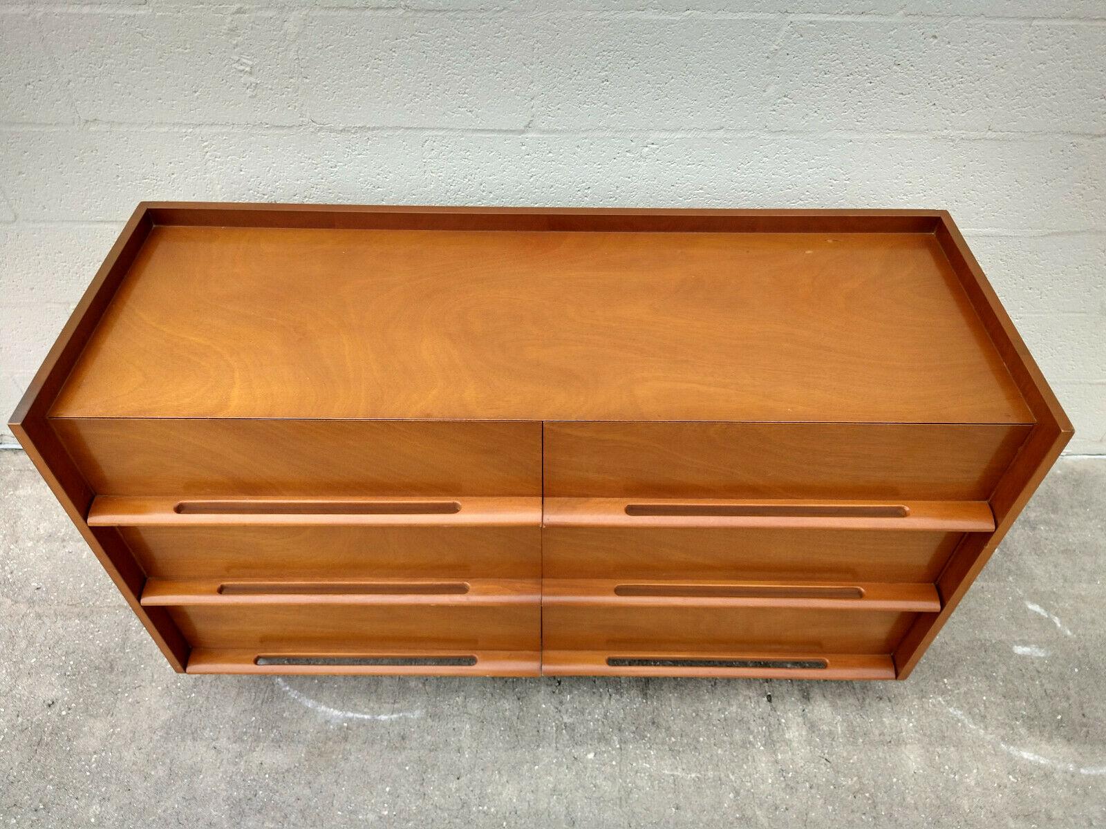 Edmond Spence dresser with six dovetailed drawers and sculpted pulls.

Mid-Century Modern masterpiece with a distinctive profile by American designer Edmond J. Spence. Spence's attention to detail shows in the set-back drawer faces, sculpted