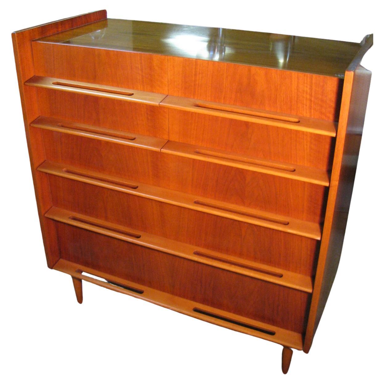 Fabulous tall walnut dresser by Edmond Spence. Created out of walnut with birch pulls. In excellent vintage condition, was well cared for. Four drawers over three large drawers. Excellent construction methods with the case being dovetailed and the