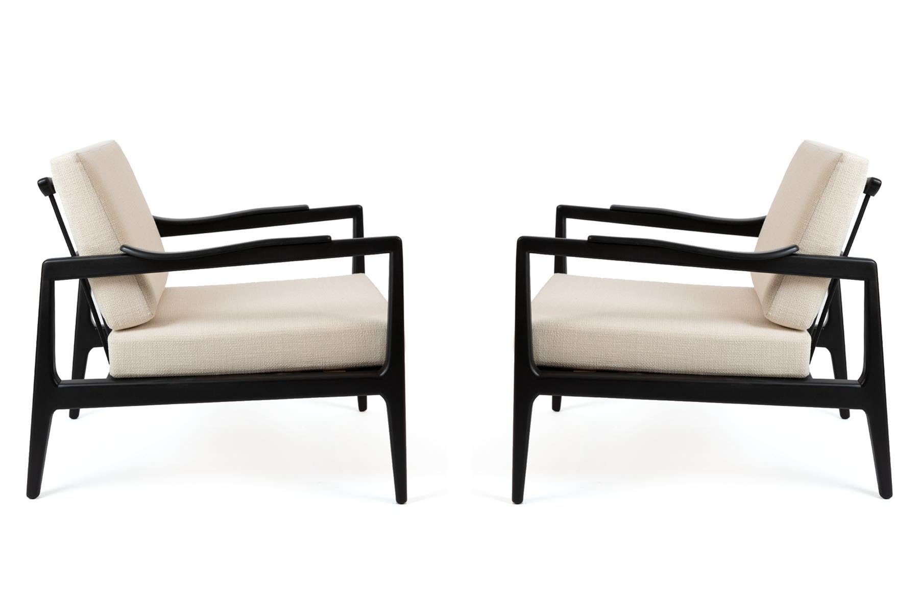 Pair of Edmond Spence lounge chairs, circa late 1950s. These examples have newly finished black lacquered frames and have been newly upholstered in a cream boucle. Price listed is for the pair.
 