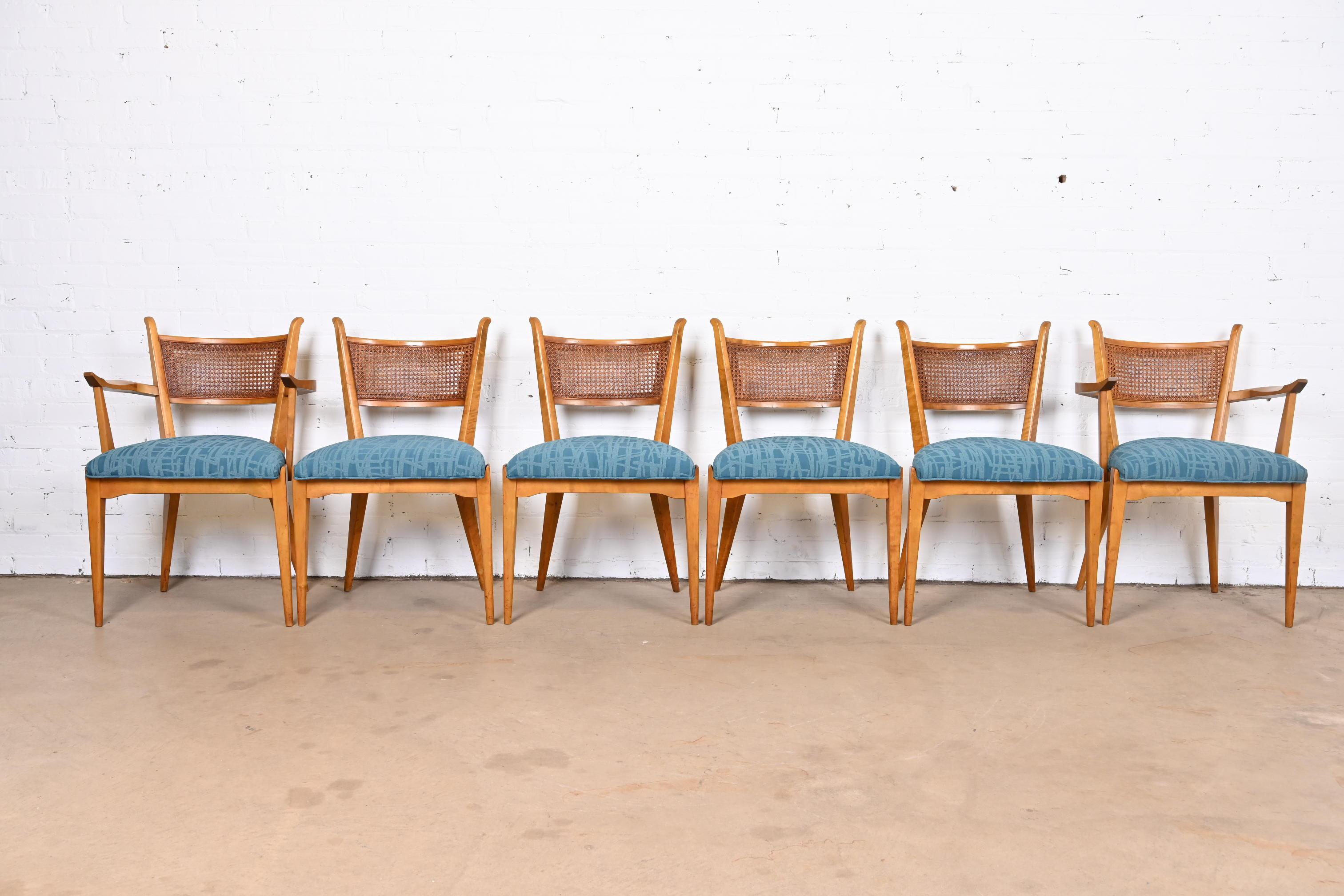 An exceptional set of six mid-century Scandinavian Modern dining chairs.

By Edmond J. Spence

Sweden, 1950s

Solid sculpted maple frames, with caned seat backs and upholstered seats.

Measures:
Side chairs - 20.75