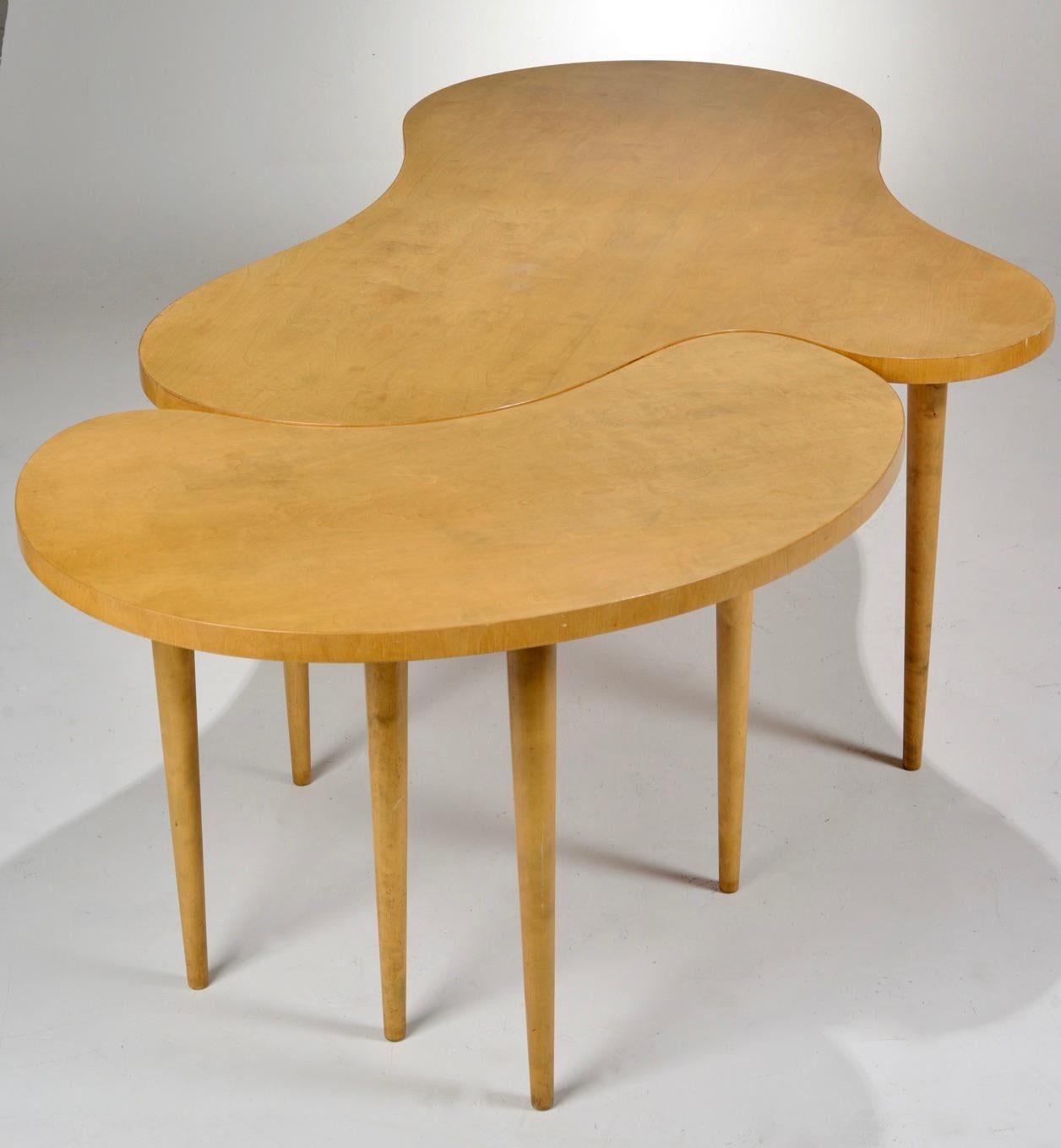 A two-part dining table by Edmond J. Spence. Bi-morphic table tops with tapered legs, made of Swedish birch.

Table extension adds additional 24