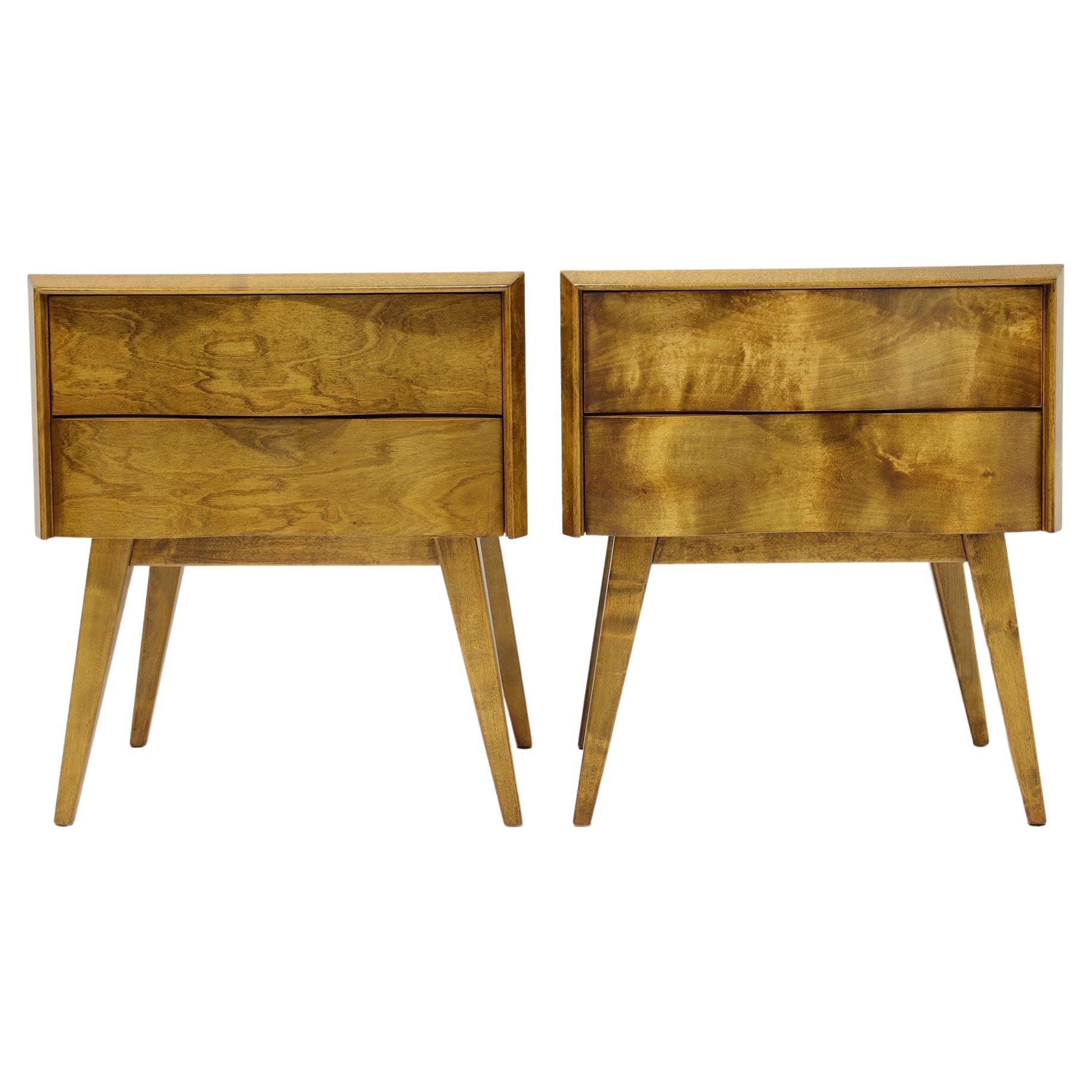 Pair of Swedish Mid-Century (1940s) wave front birchwood nightstands with two drawers in a birchwood case resting on four tapered angled legs. 