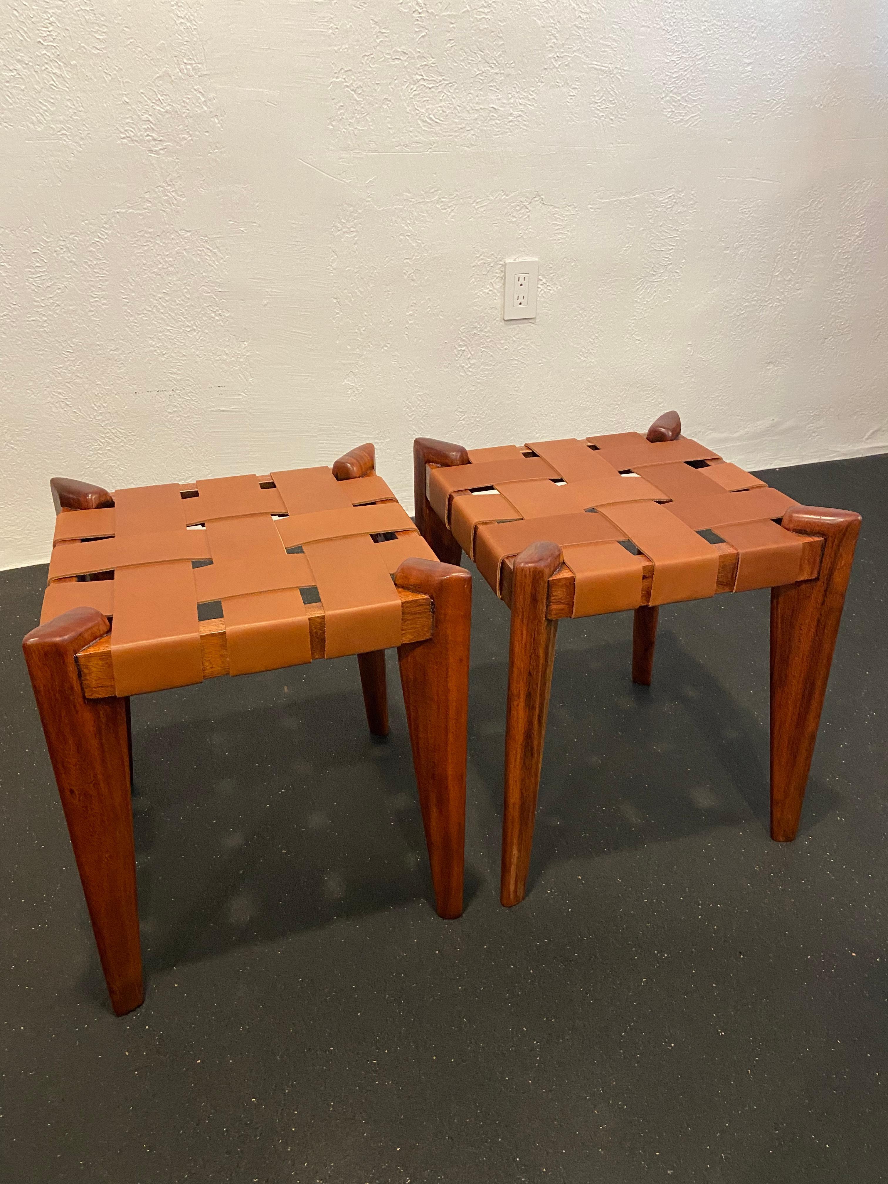 Edmond Spence woven leather stools. Constructed of mesquite wood which has different shading throughout typical of the wood. The stools have been refinished with new leather straps applied. 

Would work well in a variety of interiors such as