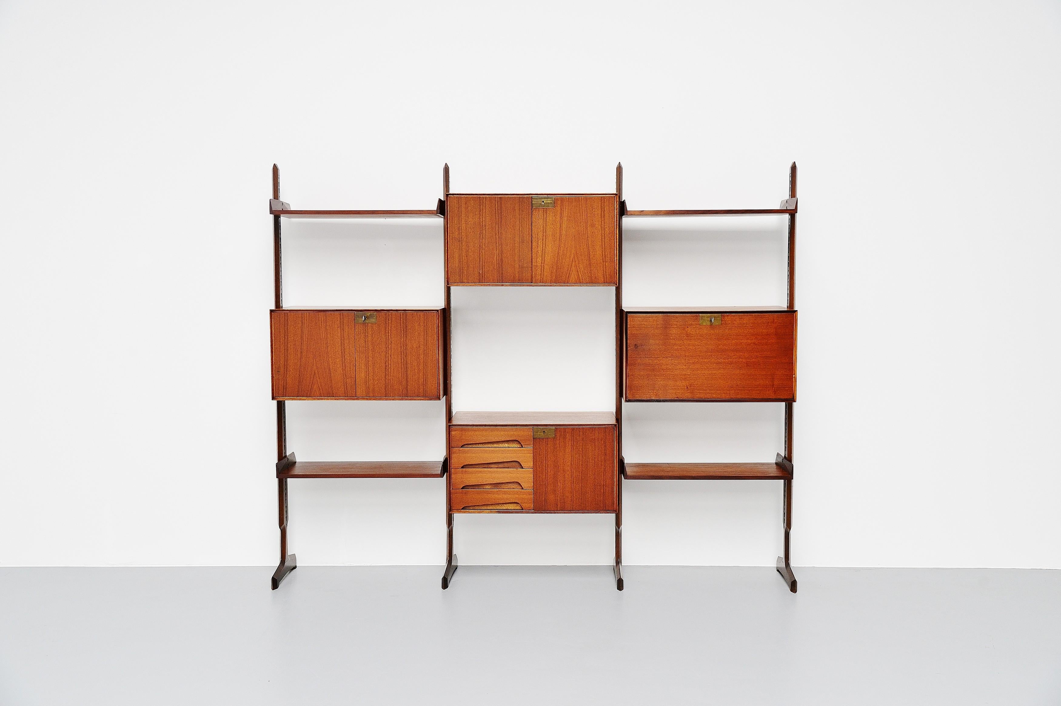 Very nice and elegant free standing shelving unit / bookcase designed by Edmondo Palutari and manufactured by Vittorio Dassi, Italy, 1950. This very nice free standing shelving unit was made of teak veneer and has several shelves and cabinets to