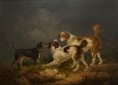 Spaniels and a terrier in a landscape