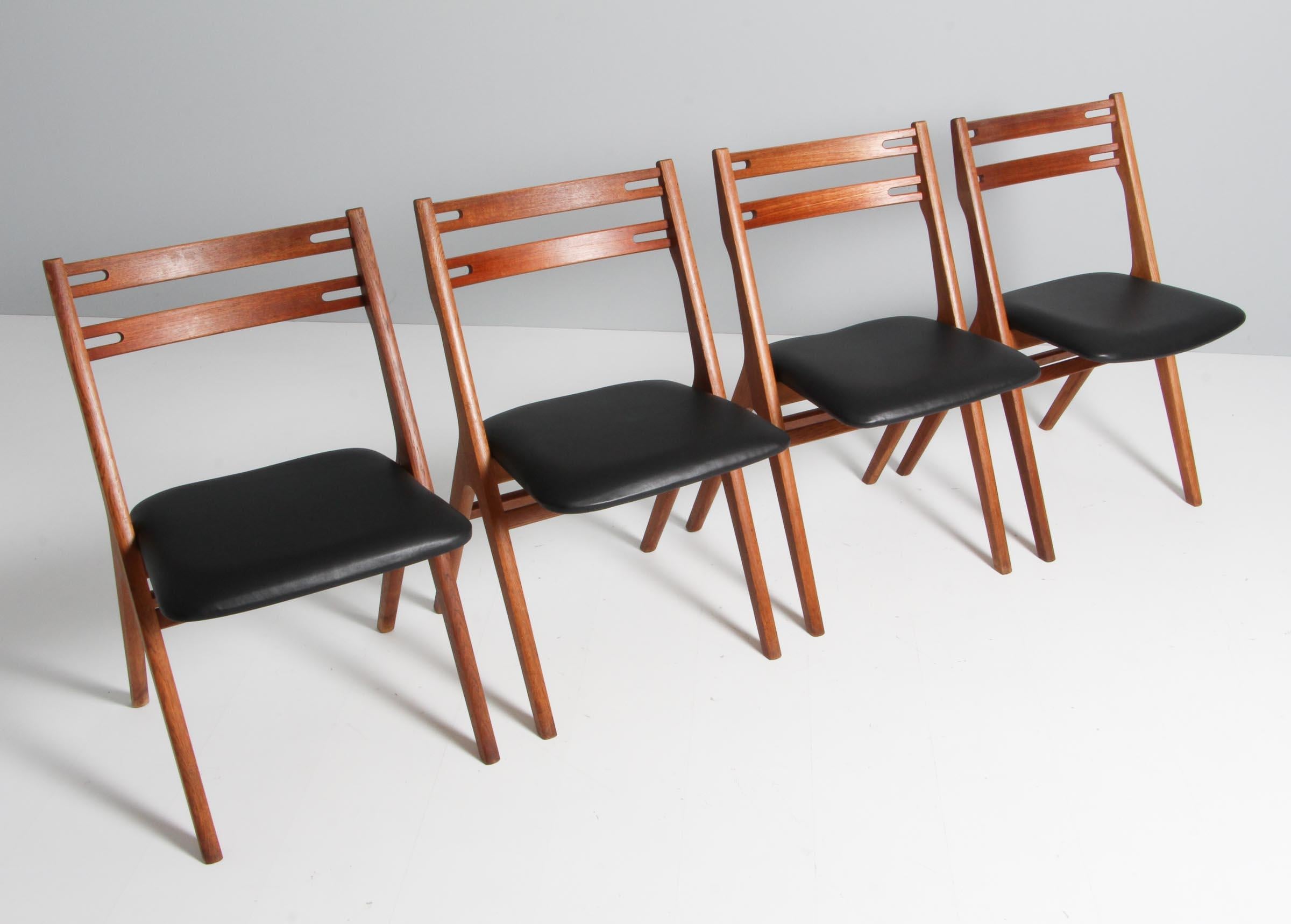 Edmund Jørgenset set of four chairs in oak and teak. New upholstered with black aniline leather.