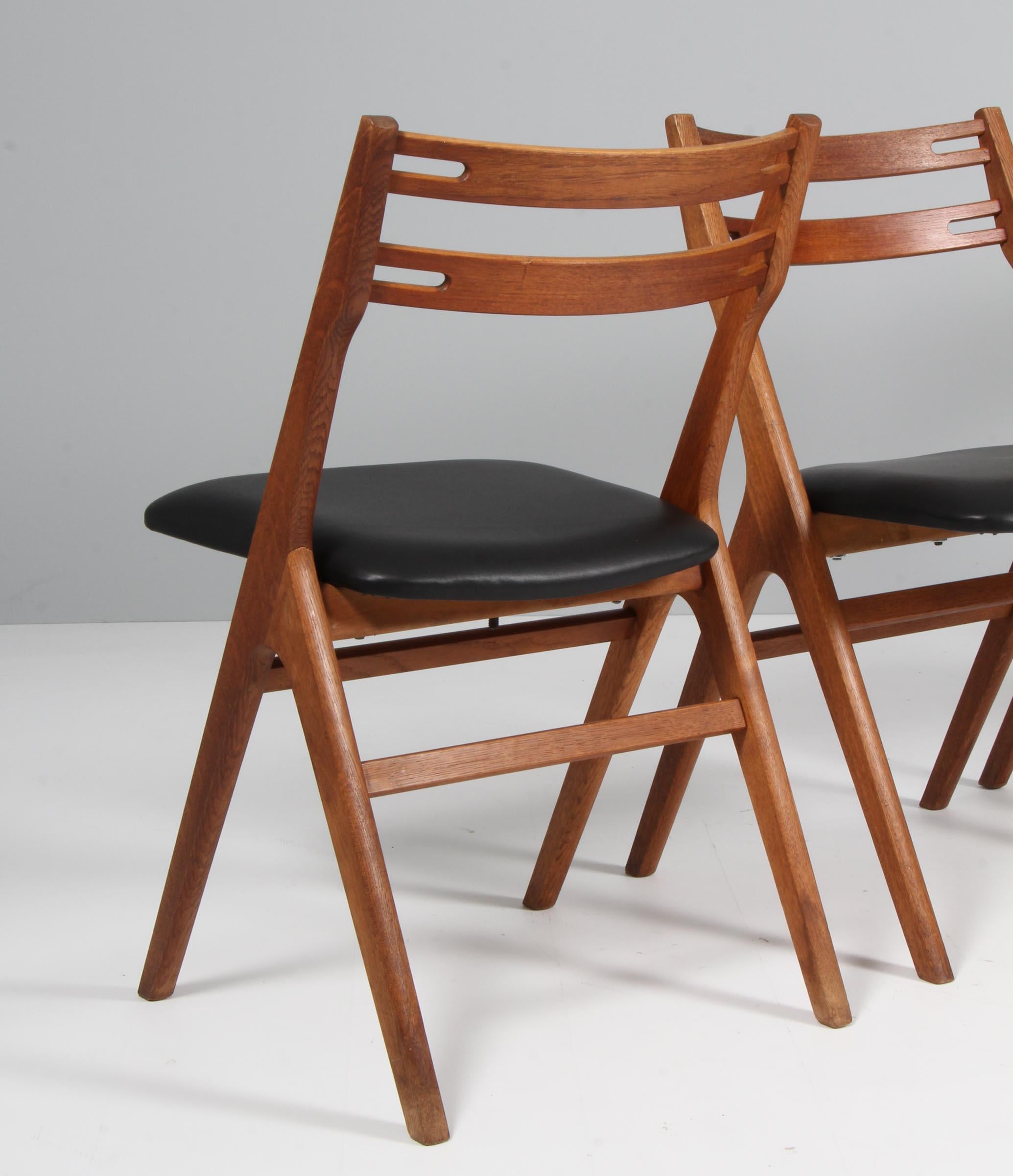 Leather Edmund Jørgensen set of four dining chairs, oak and teak For Sale