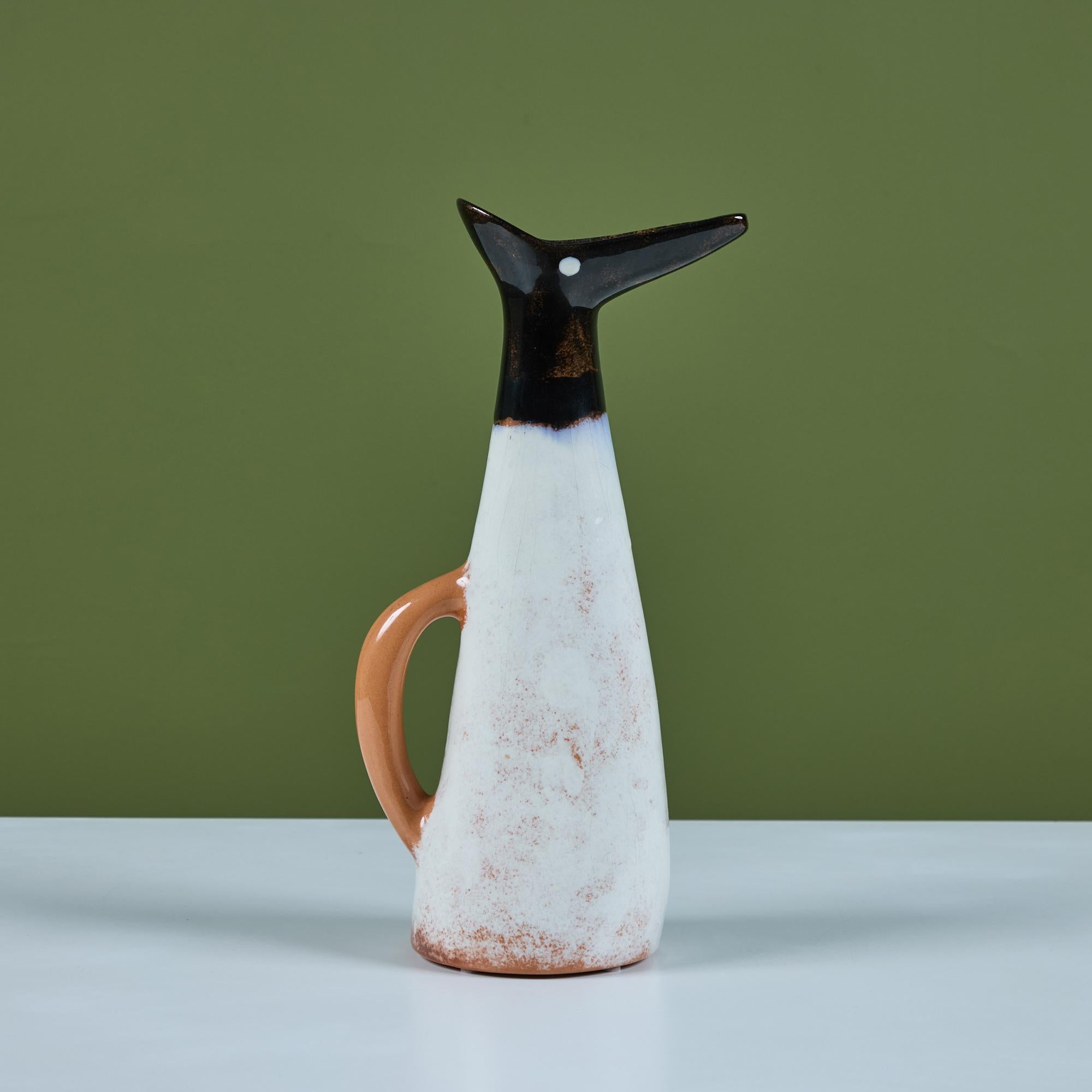 Ceramic pitcher by California artist Edmund Ronaky for Jaru. The pitcher features three different colored glazes in cream, tan and black with crazing throughout. The spout resembles a bird, with beak and eye. Signed by artist.

Dimensions
5.5