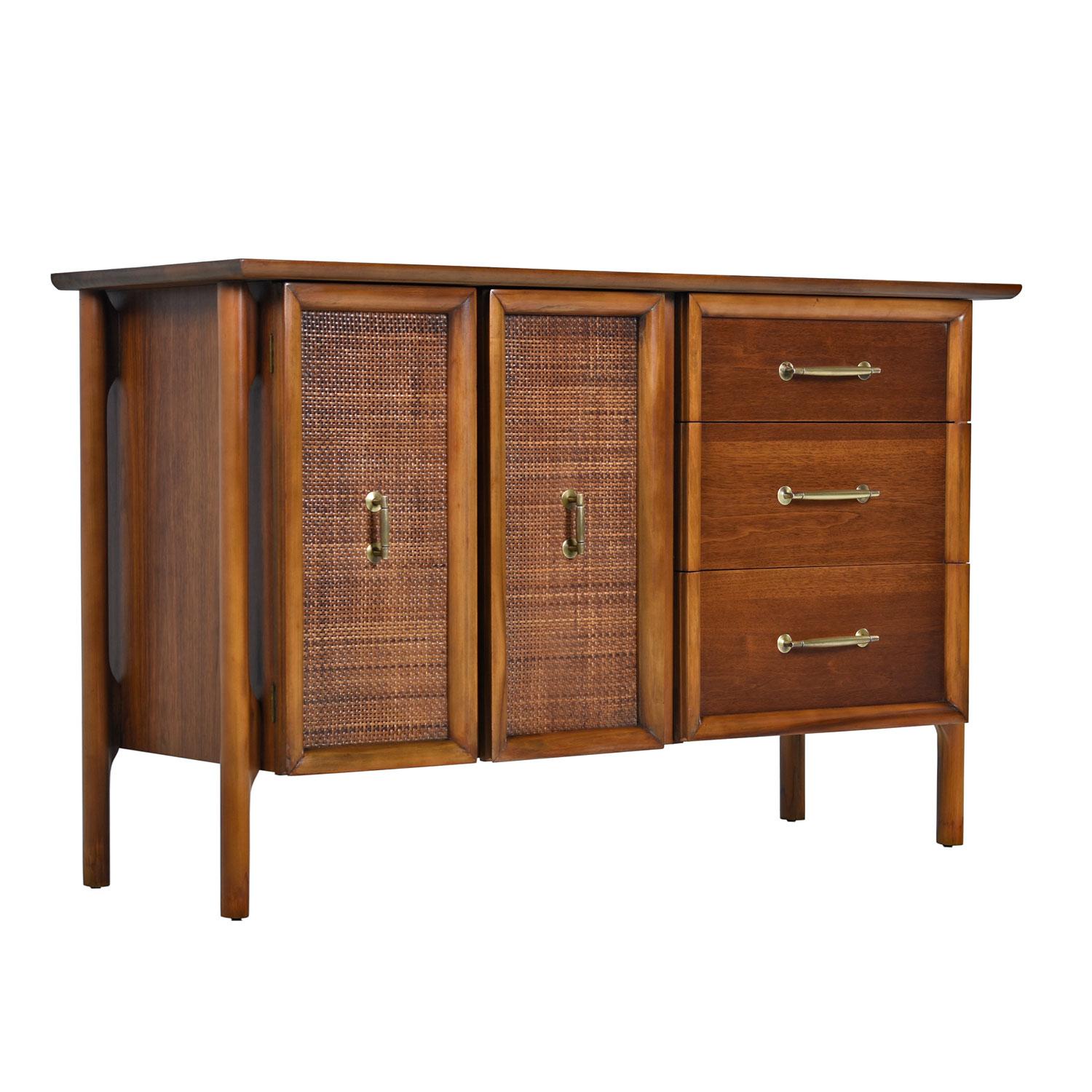 Restored, Mid-Century Modern credenza with cane front cabinet doors and sleek brass accent handle hardware. Quality American construction paired with refined esthetic. We love this piece. The 4-post architectural design is inspired by the works of