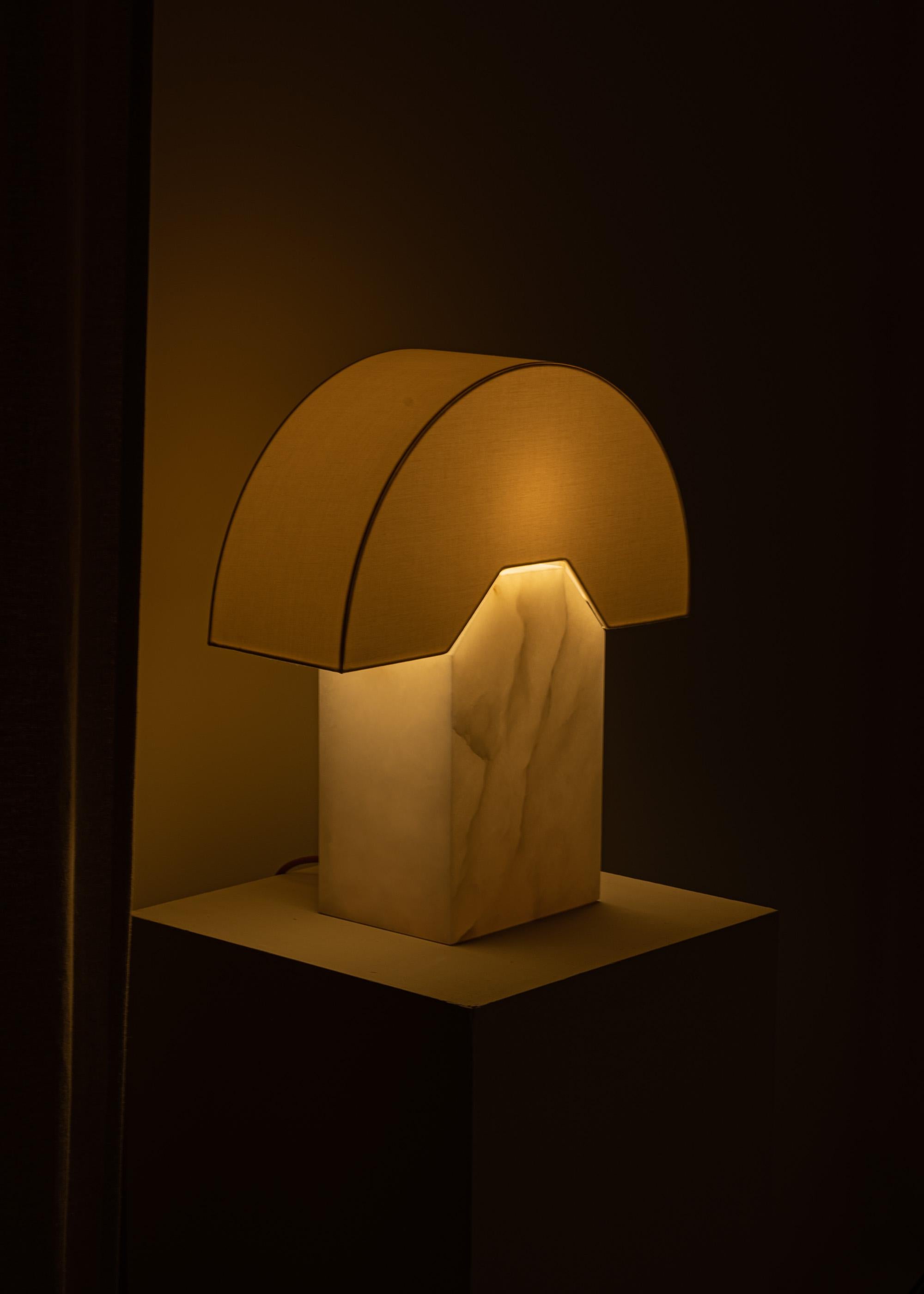 The Edna table lamp is the first lamp we designed, it was inspired by a cartoon character representing an abstract human back shape. One of our best seller, for both modern and contemporary interiors. The unique cotton lampshade marries with