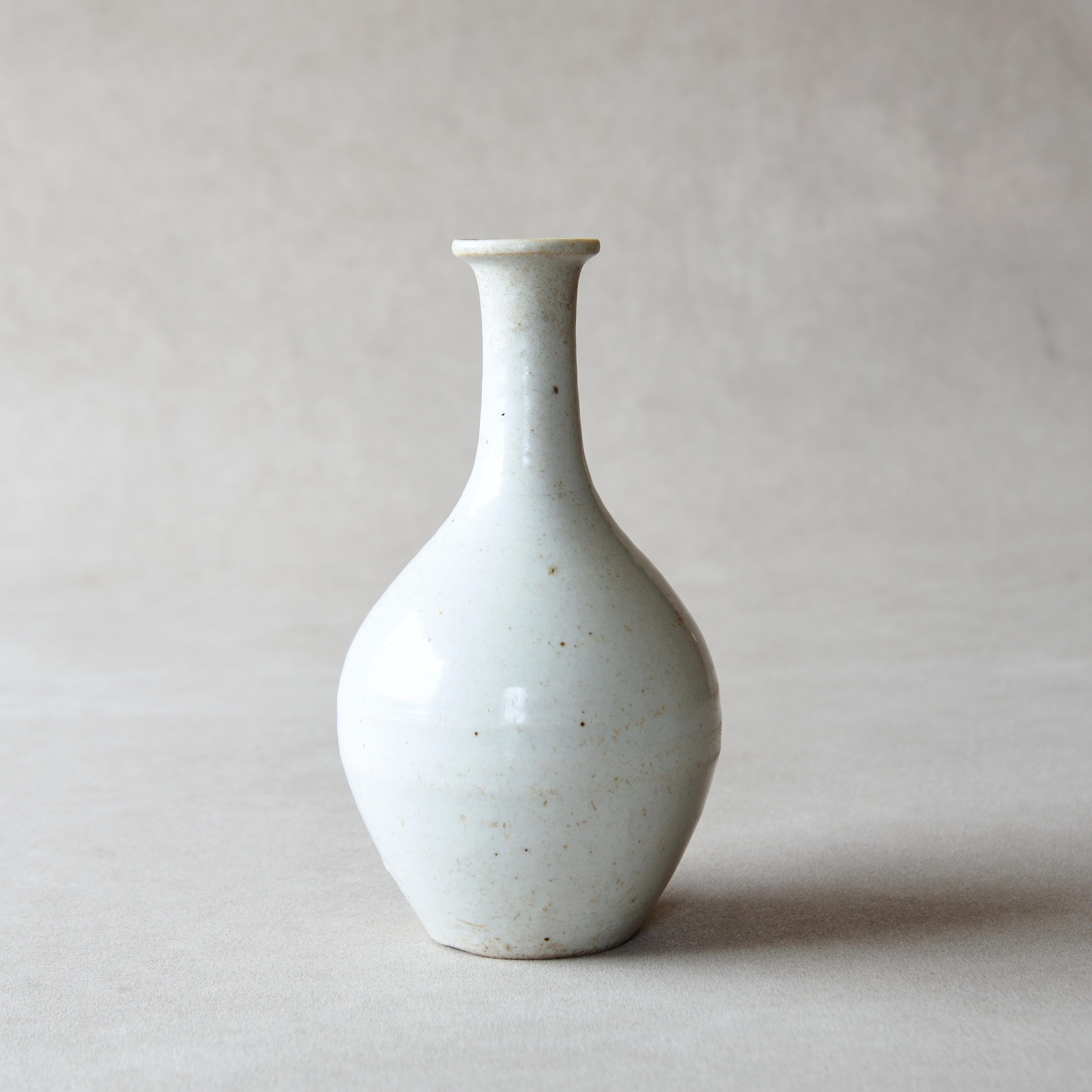 Japanese Hasami ware kurawanka-type white porcelain tokkuri (sake flask), mid-late Edo period, mid 18th – early 19th century, approx. H 19.7 x D 10.5cm (7.75 x 4.13in). Characteristically calm and refined white texture with such pale blue-gray