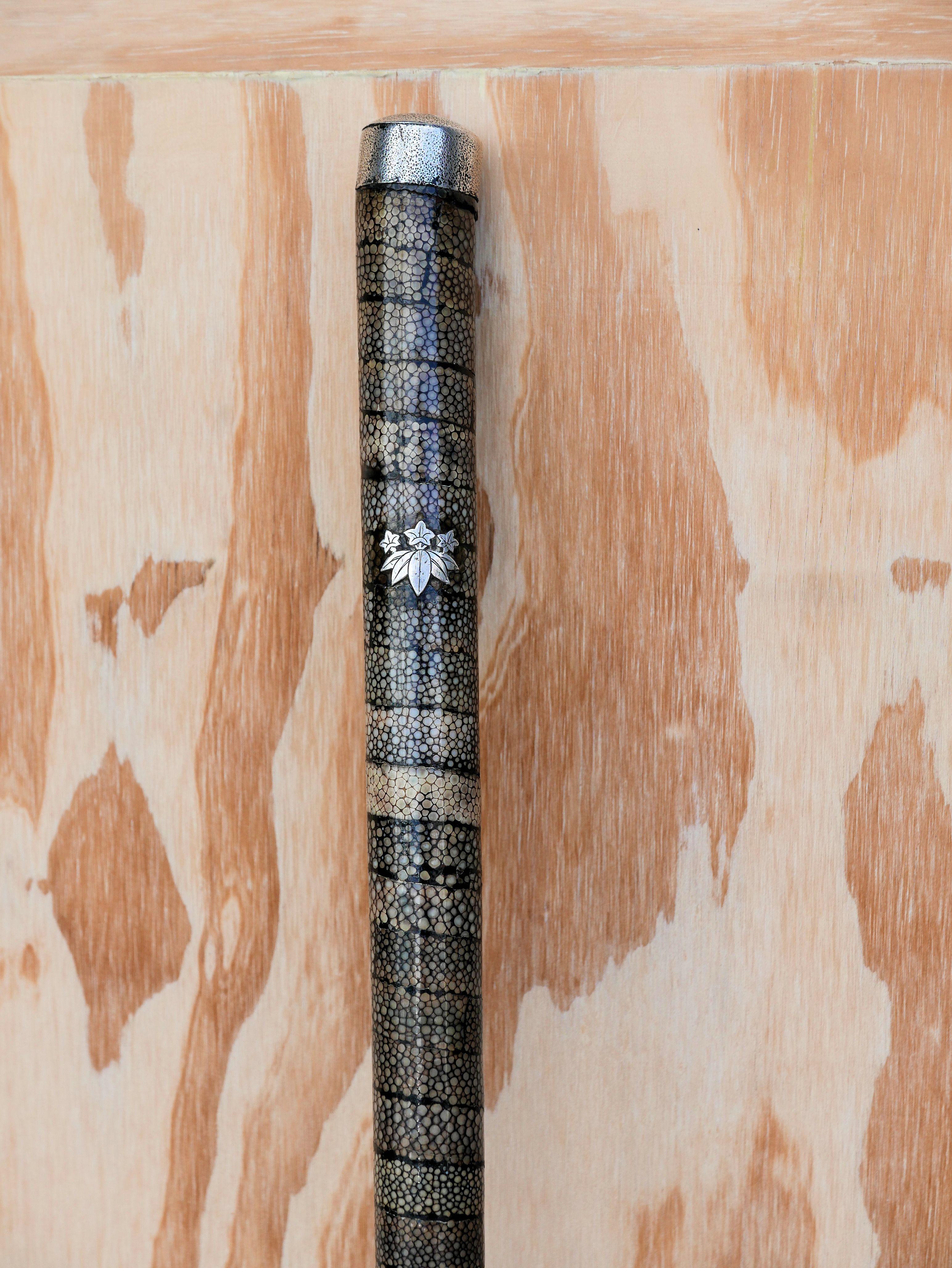 Rare late 19th century Meiji period cane clad in spiraled shagreen with the Minamoto Clan Crest in sterling, which at one point was the imperial family and a shogun of Japan. Cap is sterling and the bottom foot is hand forged. The Minamoto Clan