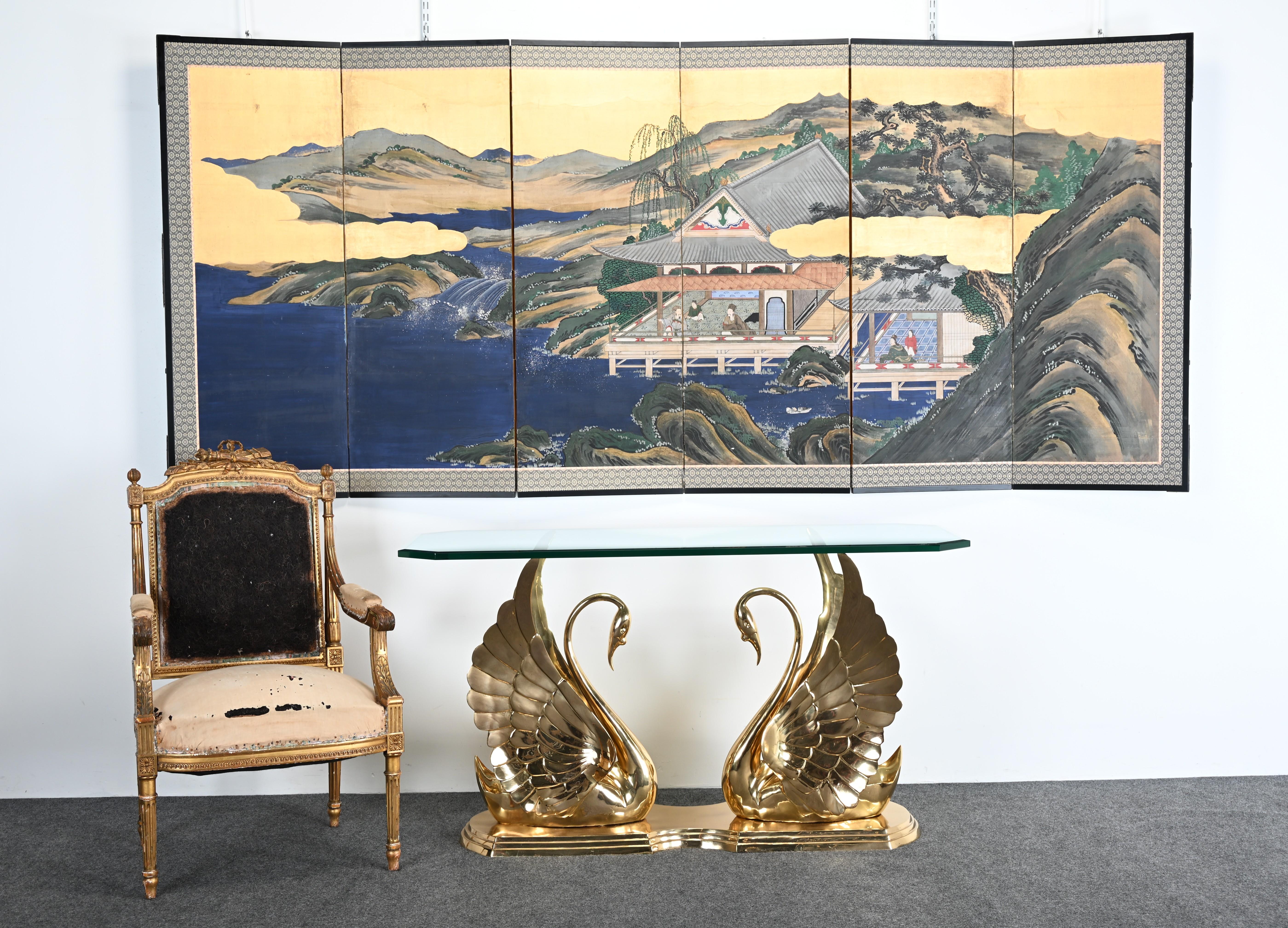 This Asian screen print is a stunning six-panel byobu (folding screen) featuring a traditional Japanese landscape. The artwork showcases a serene scene with a lakeside pavilion set against a backdrop of rugged mountains and cascading waterfalls. The