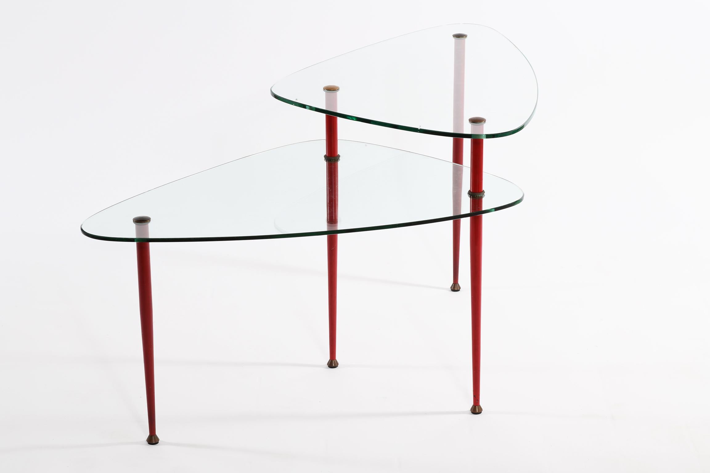 Smoking table with double top in ground and tempered glass (shows the characteristic signs to be tempered) legs in natural and red lacquered brass.
This table can be used in front of the sofas or alongside.
The legs are unscrewed and can be