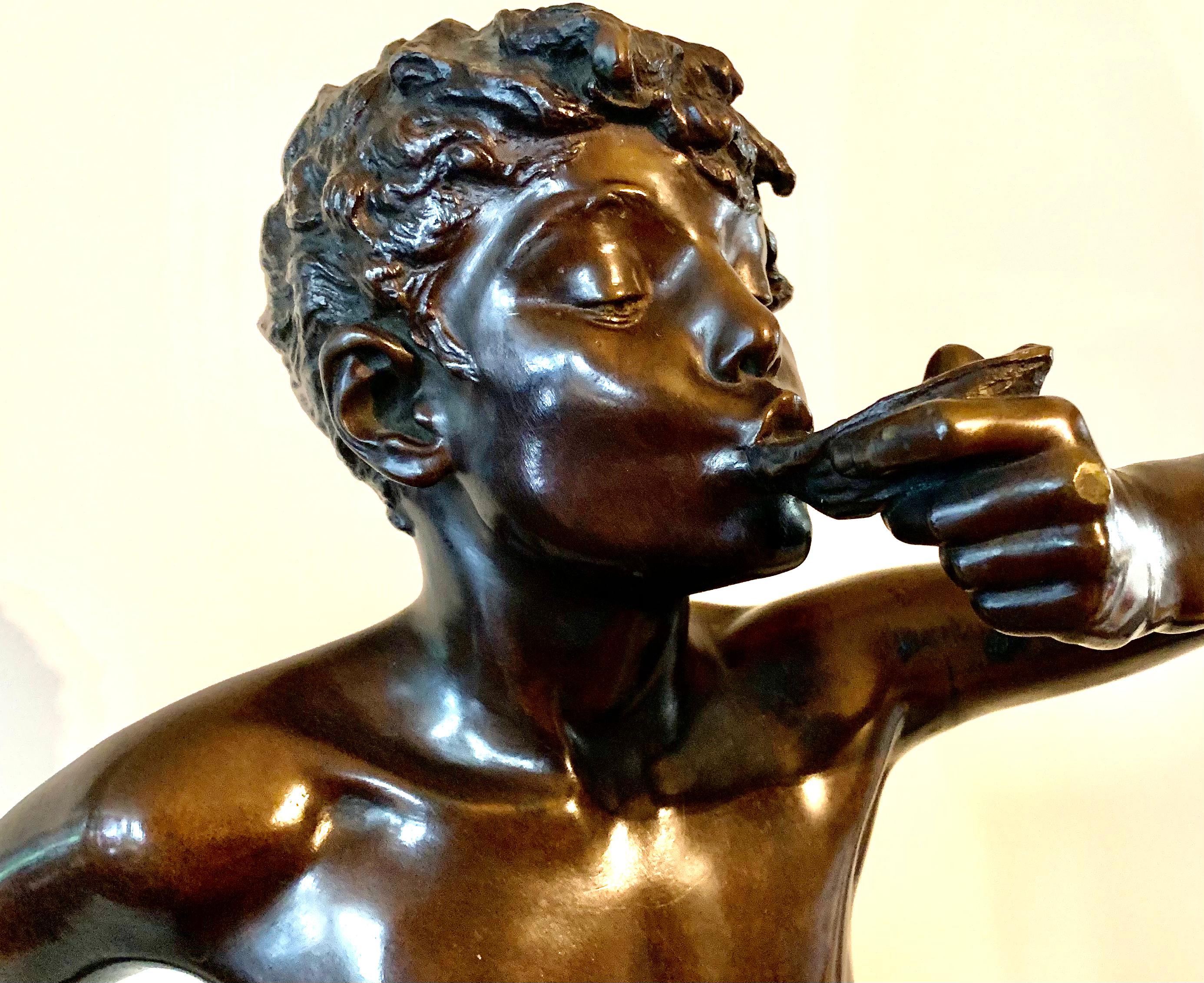 Large Edouard Drouot, Siot-Decauville Fondeur Paris patinated bronze sculpture of a youth enjoying an oyster. The young boy stands on a rock formation, leaning forward to avoid the oyster juices on his body, with his left arm raised to his mouth