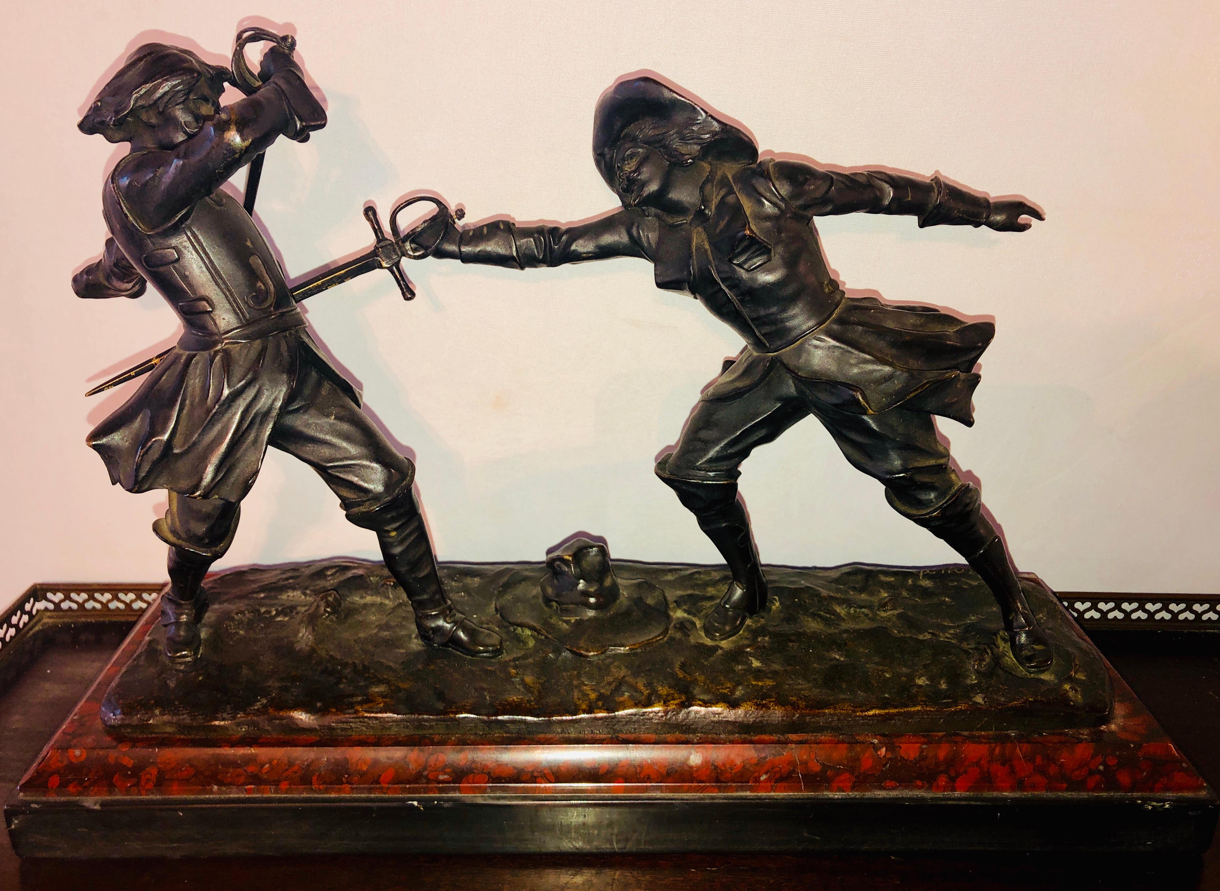 Edouard Drouot French bronze depicting two fencers on marble base. Modeled as a fencing dual action scene on a naturalistic base, raised on a griotte marble rectangular base, the bronze signed 'E. Drouot. The base bearing a bronze engraved plaque