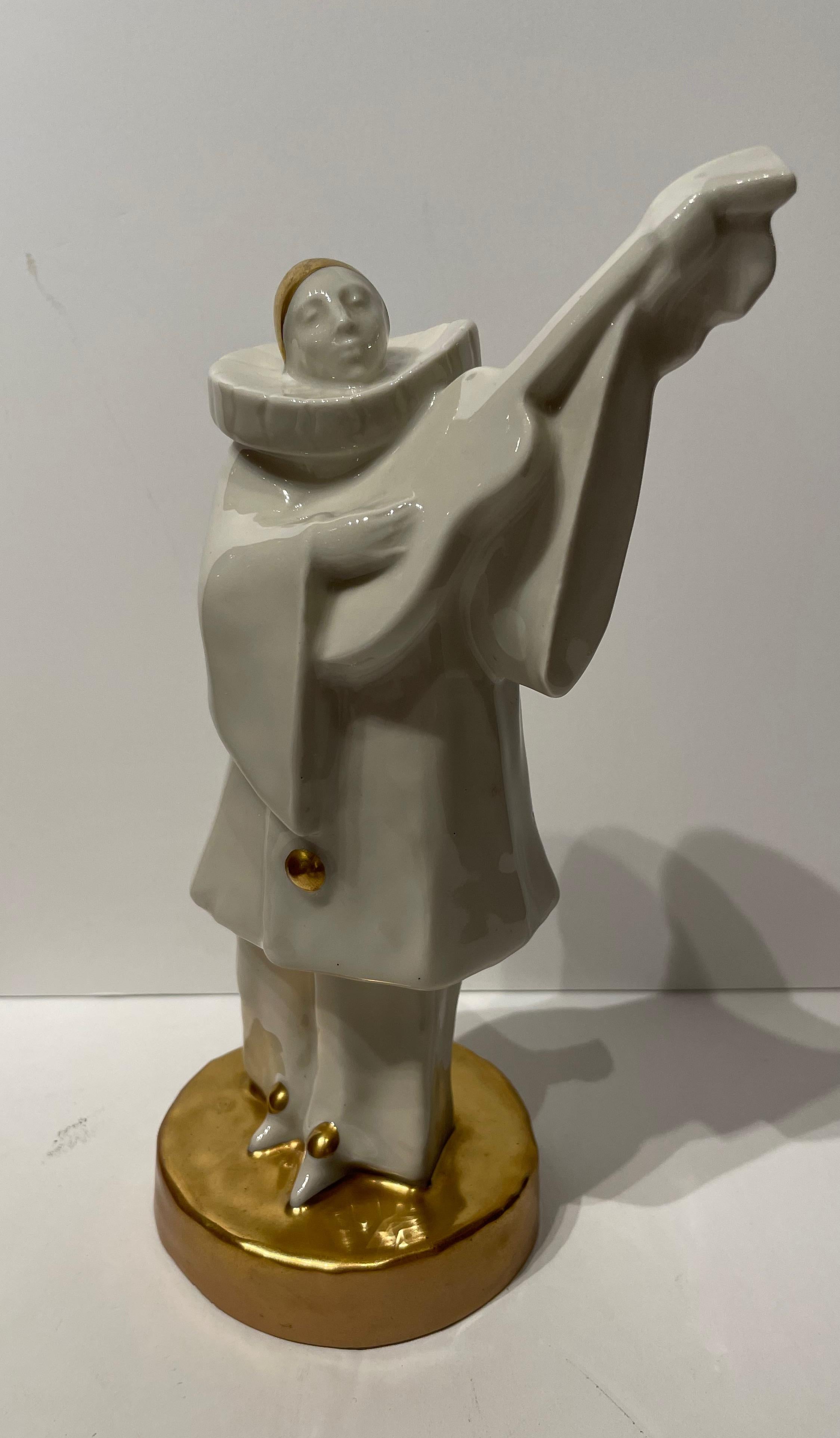 Edouard Marcel Sandoz Porcelain Musician Guitarist Statue. Figure “Pierrot Musicien”, circa 1917. Hard-paste porcelain with a white glaze, and painted gold. Signed to the base. Théodore Haviland & M. Sandoz monogram. For a similar example see the