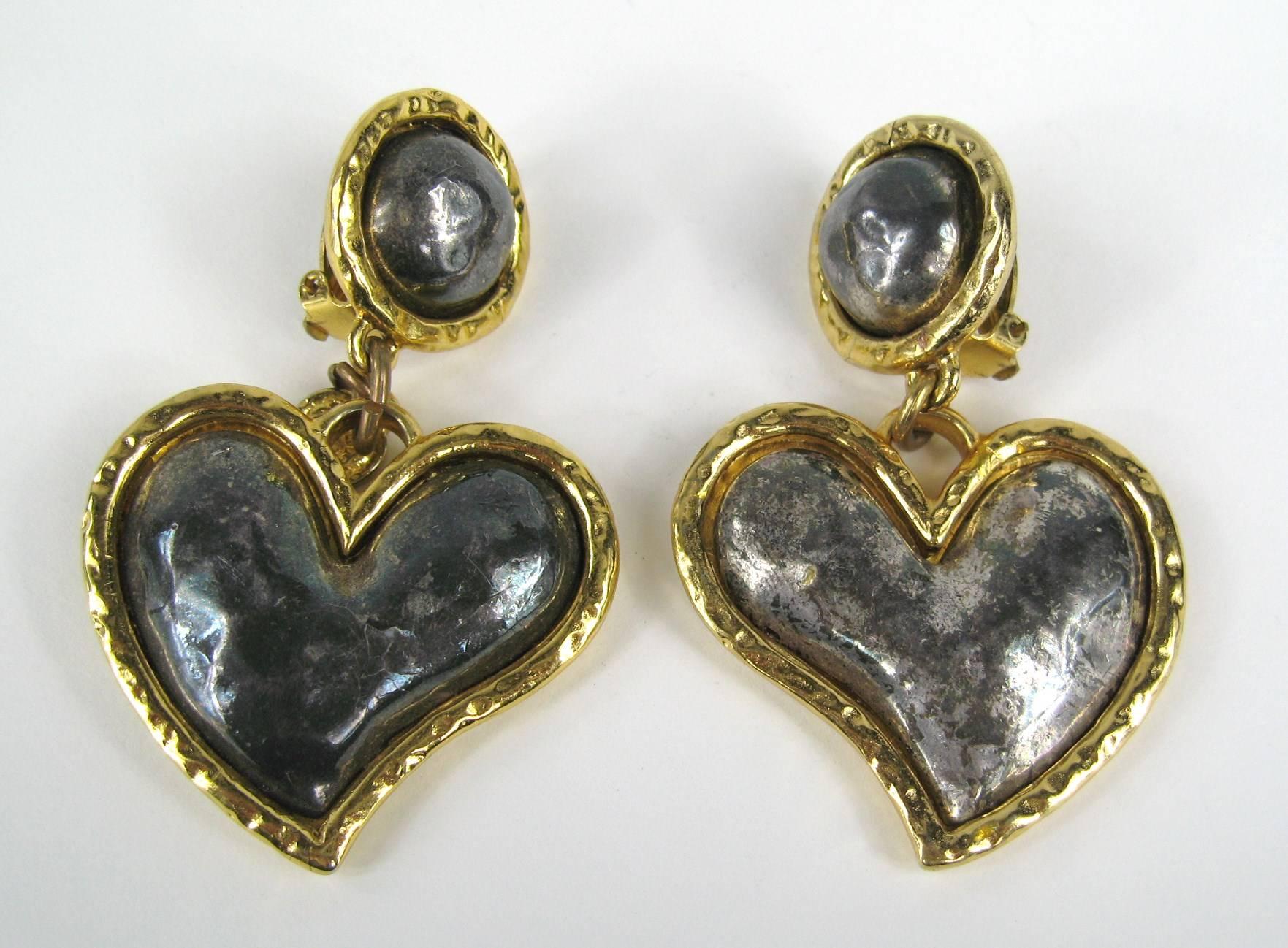 Pair of Large Heart-shaped dangle earring clip on's Circa 80s. Measuring 3.87 in. x 1.83 in. Hallmarked on the back.  Purchased and never worn as is with about 90% of our costume jewelry This is out of a massive collection of Designer Clothing as