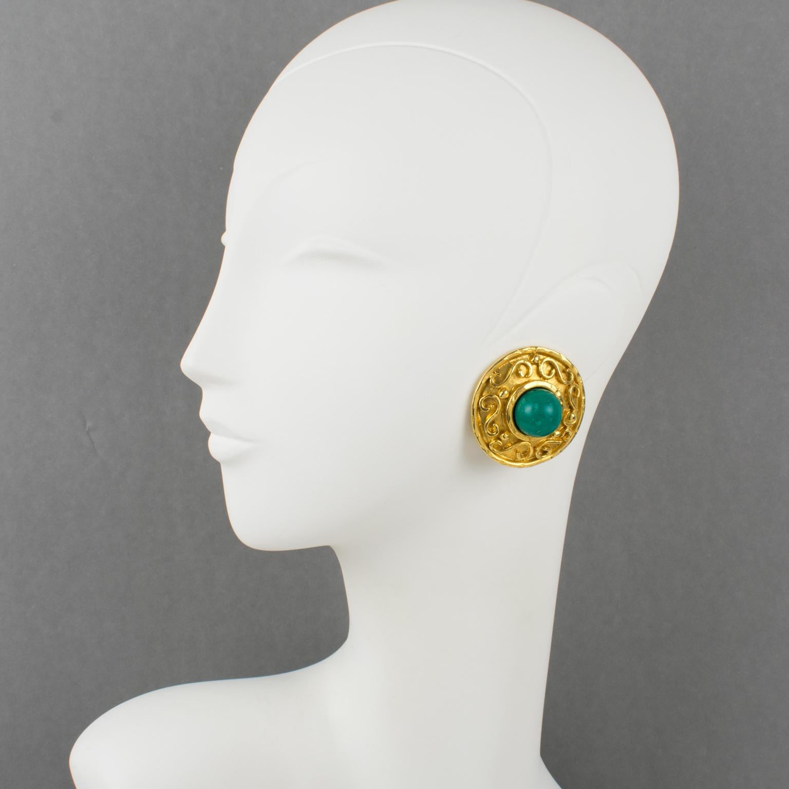 French designer Edouard Rambaud Paris designed those stunning Byzantine-inspired clip-on earrings. They feature a massive shiny, gilded metal rounded donut shape, all textured and ornate with turquoise-like resin bead cabochon. Each piece is signed