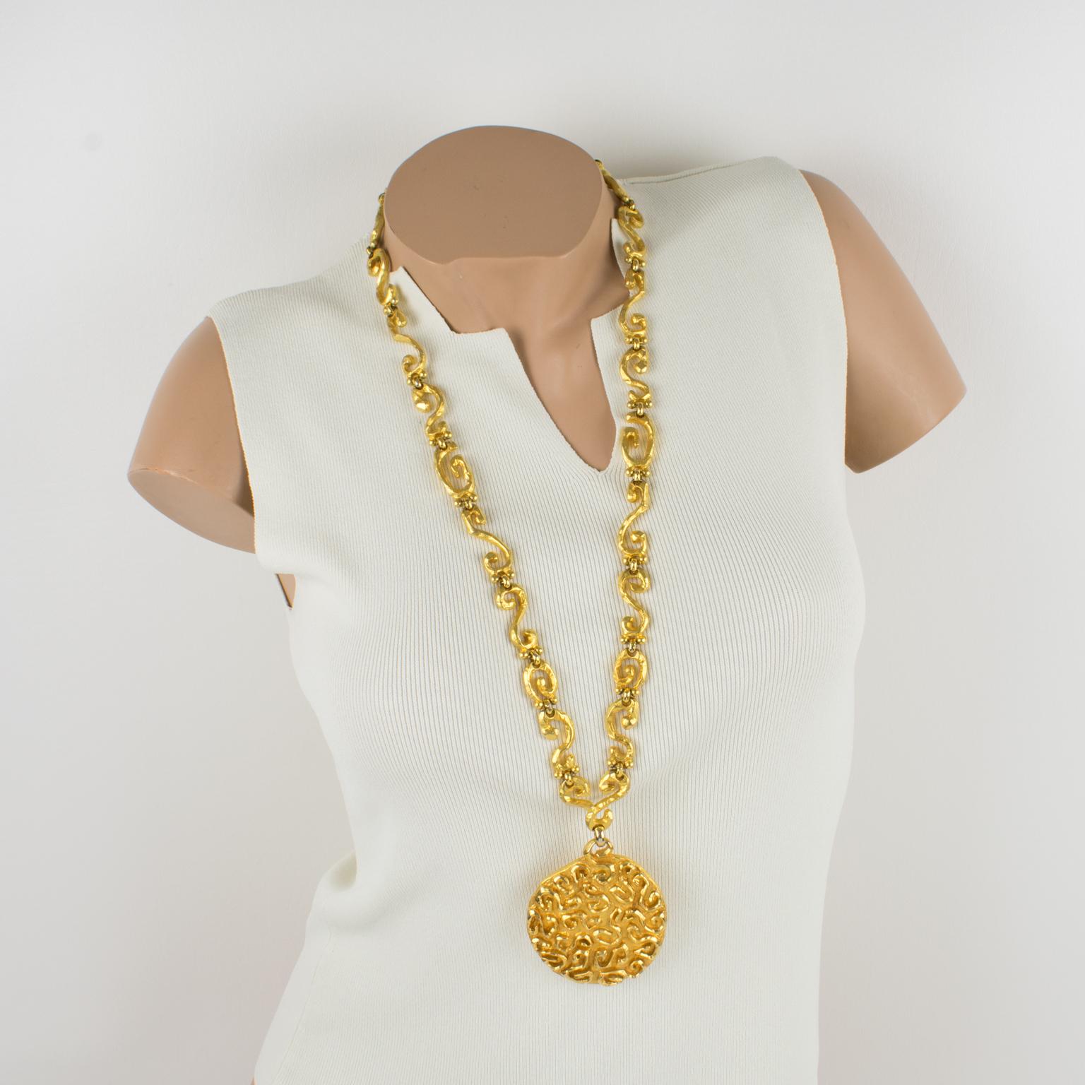 This stunning extra-long Edouard Rambaud Paris medallion necklace was a Byzantine revival-inspired design. The gilded metal heavy worked chain is all carved and textured with a satin finish and ornate with an impressive round pendant medallion with