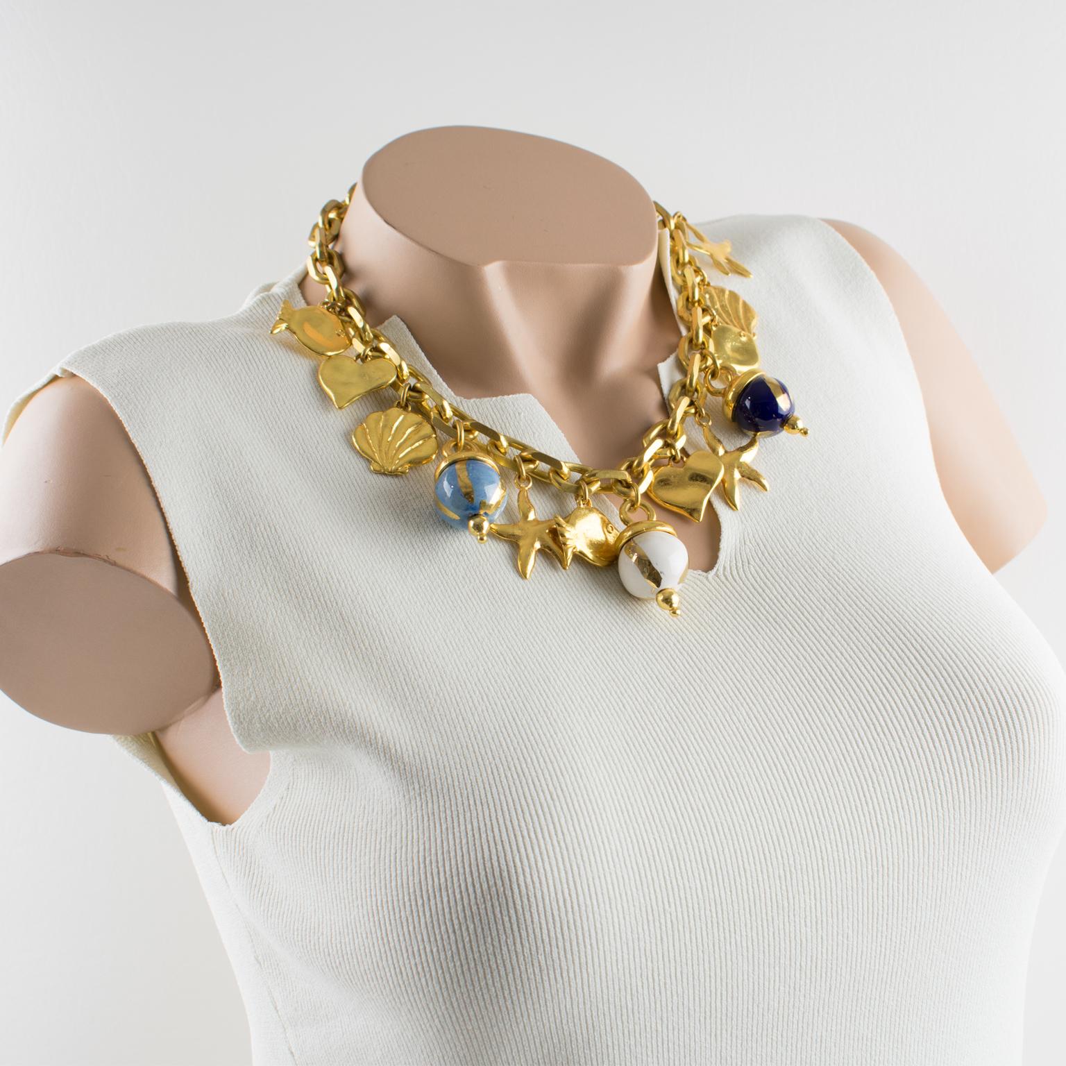Very chic Edouard Rambaud Paris signed choker necklace. Nautical inspired design with large gilt metal chain ornate with dangling charms. Among the charms you have, ceramic beads in assorted white, cerulean blue and cobalt blue colors ornate with