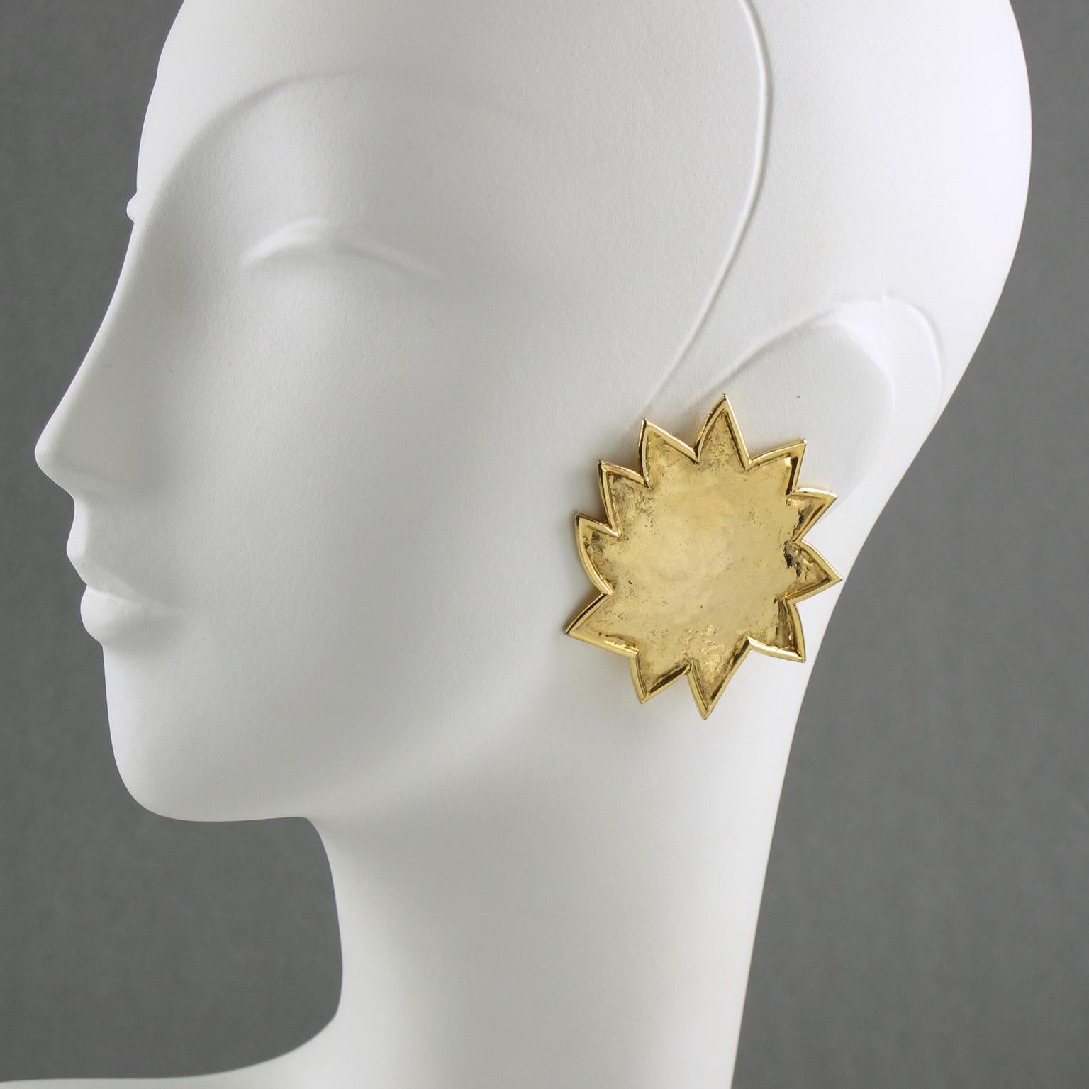 Elegant Edouard Rambaud Paris clip-on Earrings. Oversized dimensional carved sun with asymmetric shape in gilt metal all textured with a hand-made feel and shiny finish aspect. Signed at the back by this well-known French Designer. 
Measurements: