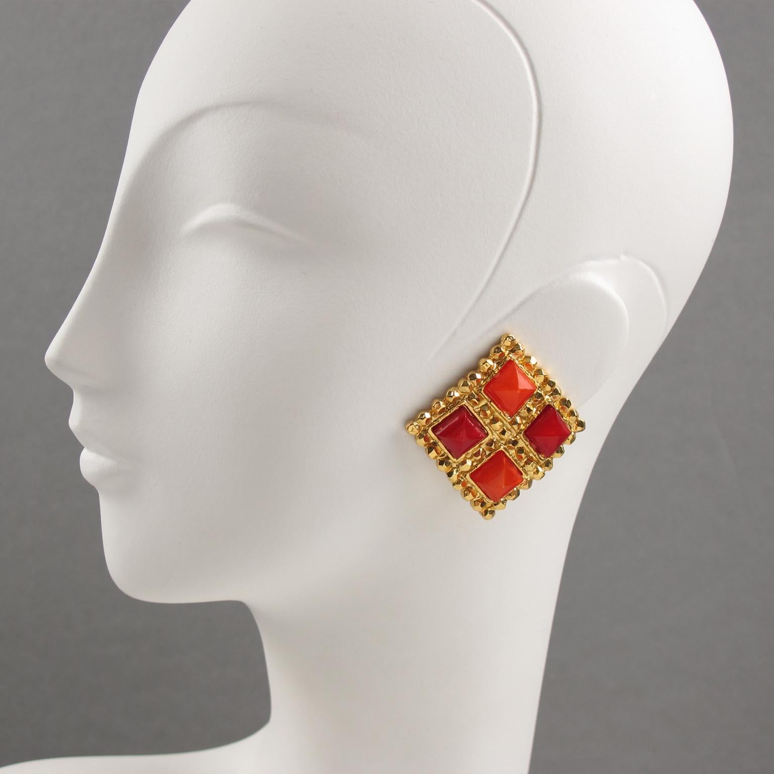 Lovely French designer Edouard Rambaud Paris signed clip-on earrings. Byzantine-inspired design with shiny gilt metal large square frame topped with geometric resin cabochons. Assorted colors of neon orange and scarlet red with a light moon-glow