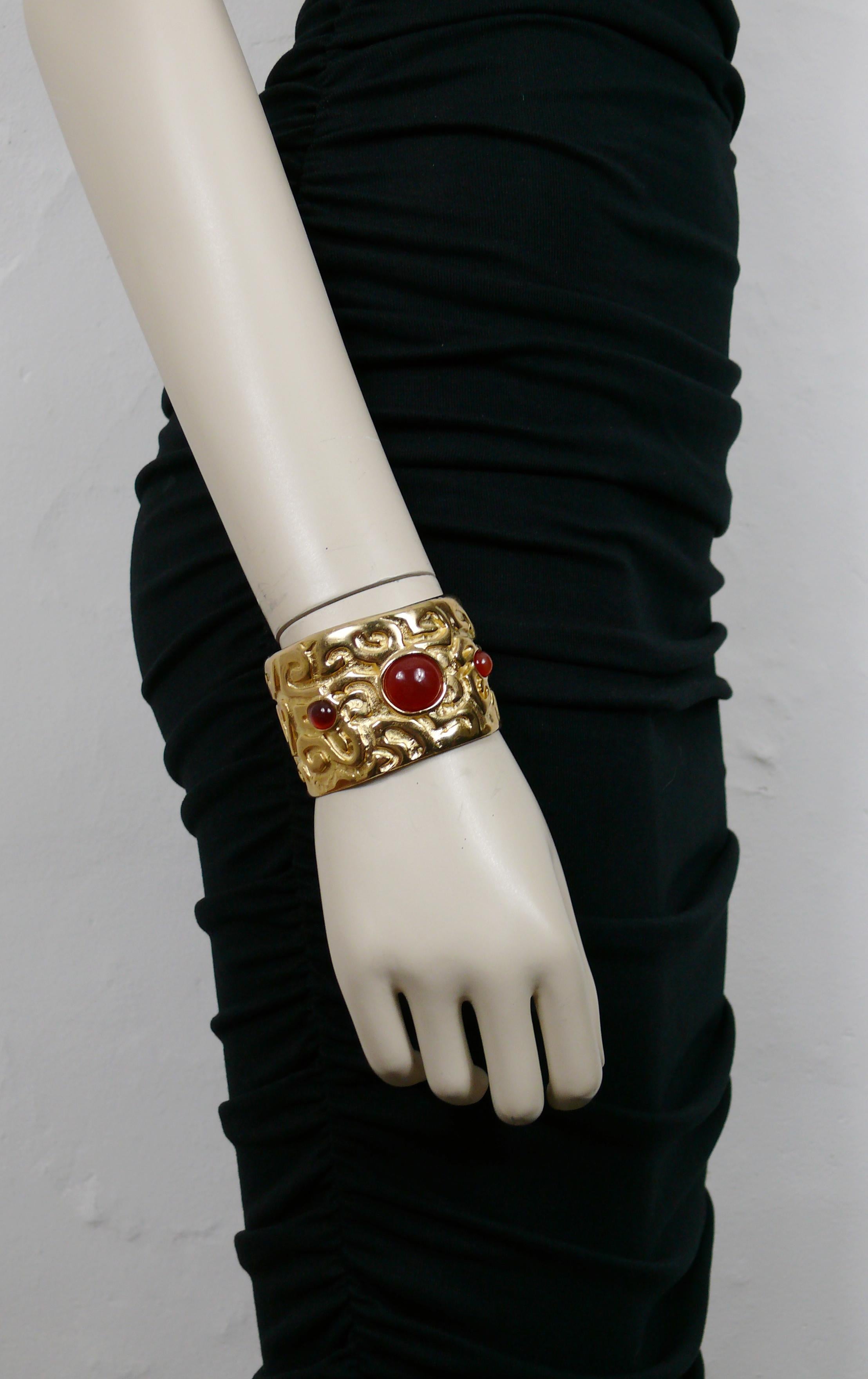 EDOUARD RAMBAUD vintage gold tone cuff bracelet featuring an arabesque design, embellished with three amber colour glass cabochons.

Embossed EDOUARD RAMBAUD Paris.

Indicative measurements : inner measurements approx. 6 cm x 5 cm (2.36 inches x