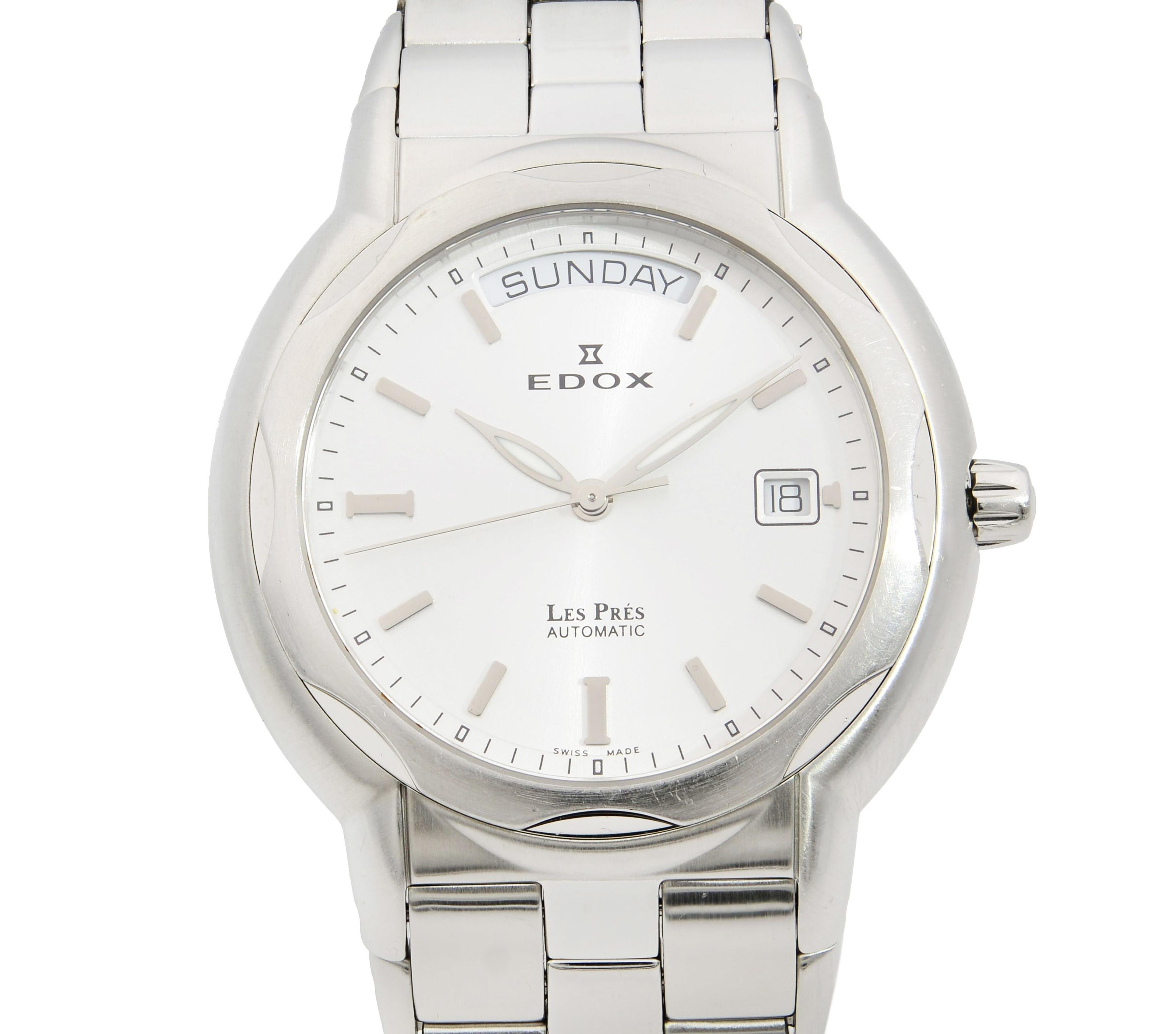 This pre-owned Edox Le Pres N/A is a beautiful men's timepiece that is powered by mechanical (automatic) movement which is cased in a stainless steel case. It has a round shape face, day & date dial and has hand sticks style markers. It is completed