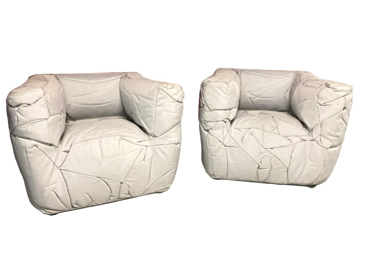 Experience comfort and style with the Sponge Chairs by Peter Traag for Edra in a beautiful stone grey color. Each chair is uniquely fabricated by cutting overside fabric pieces and letting the cooling phases create wrinkles which then start to take