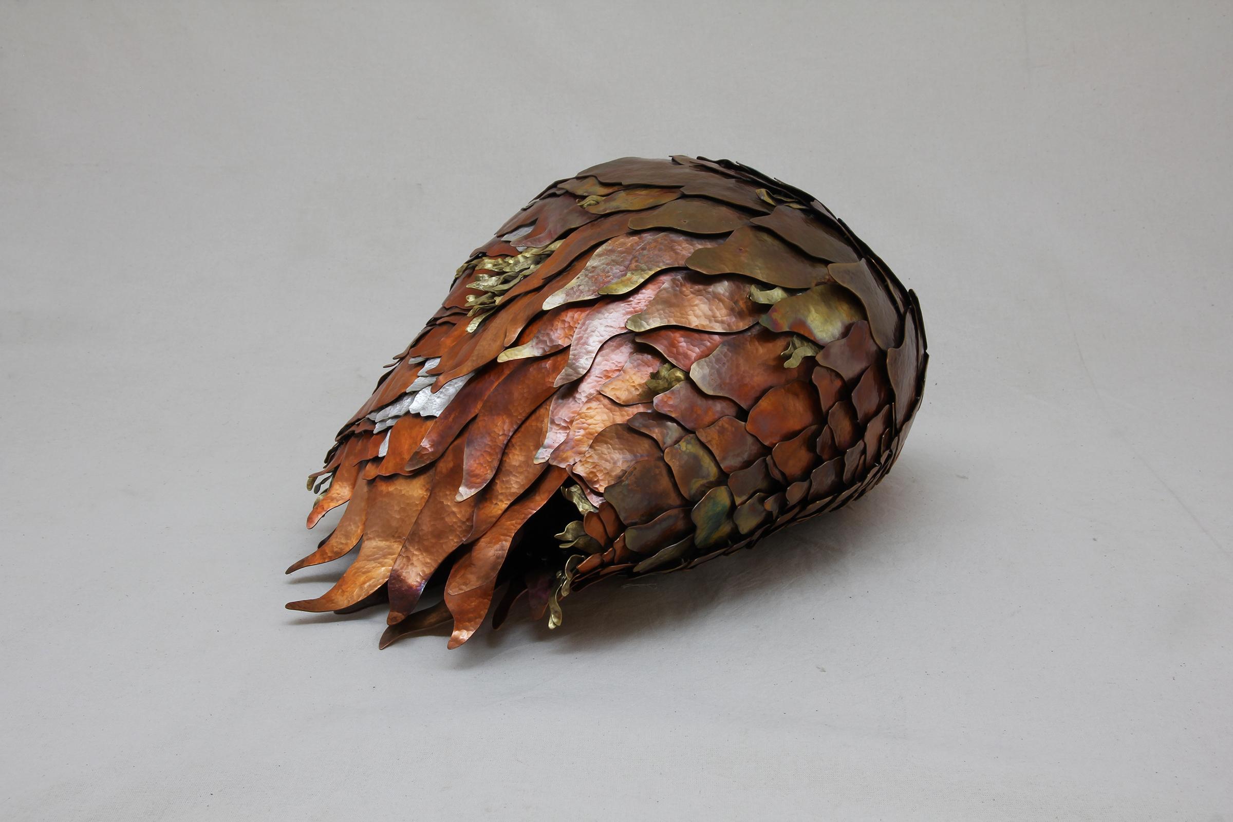 Inspirée par les formes organiques trouvées dans la nature, cette sculpture abstraite conçue par Eduardo Herrera et fabriquée en argent .950, en cuivre traité thermiquement et en tumbaga (un alliage de cuivre et de zinc), chaque maillon de cette