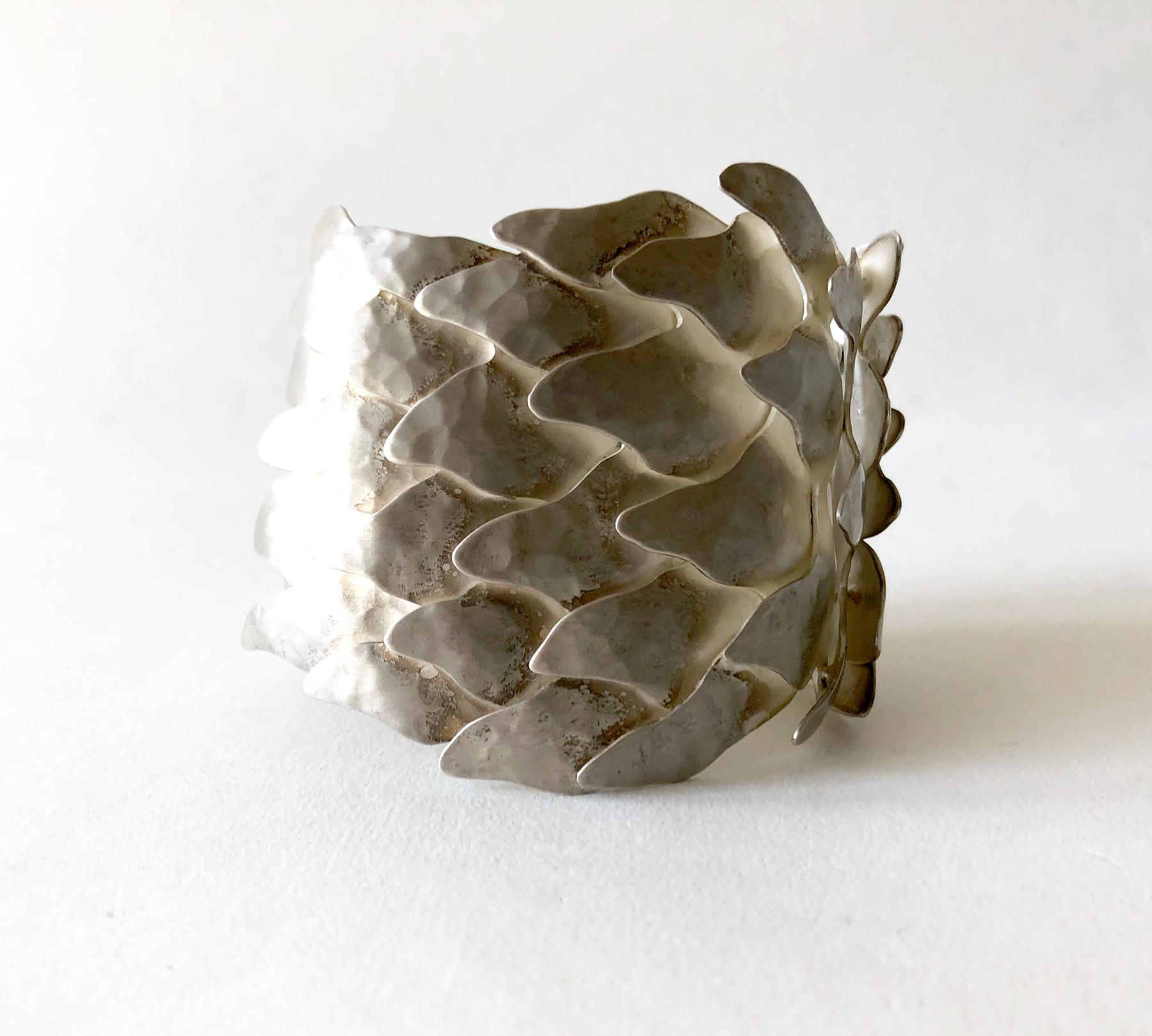 Undulating silver Scales bracelet by Mexican architect turned jeweler, Eduardo Herrera. The numerous overlapping matte finish links give the bracelet a surprising fluidity, given its size. It is very comfortable to wear. The bracelet is 2 1/2