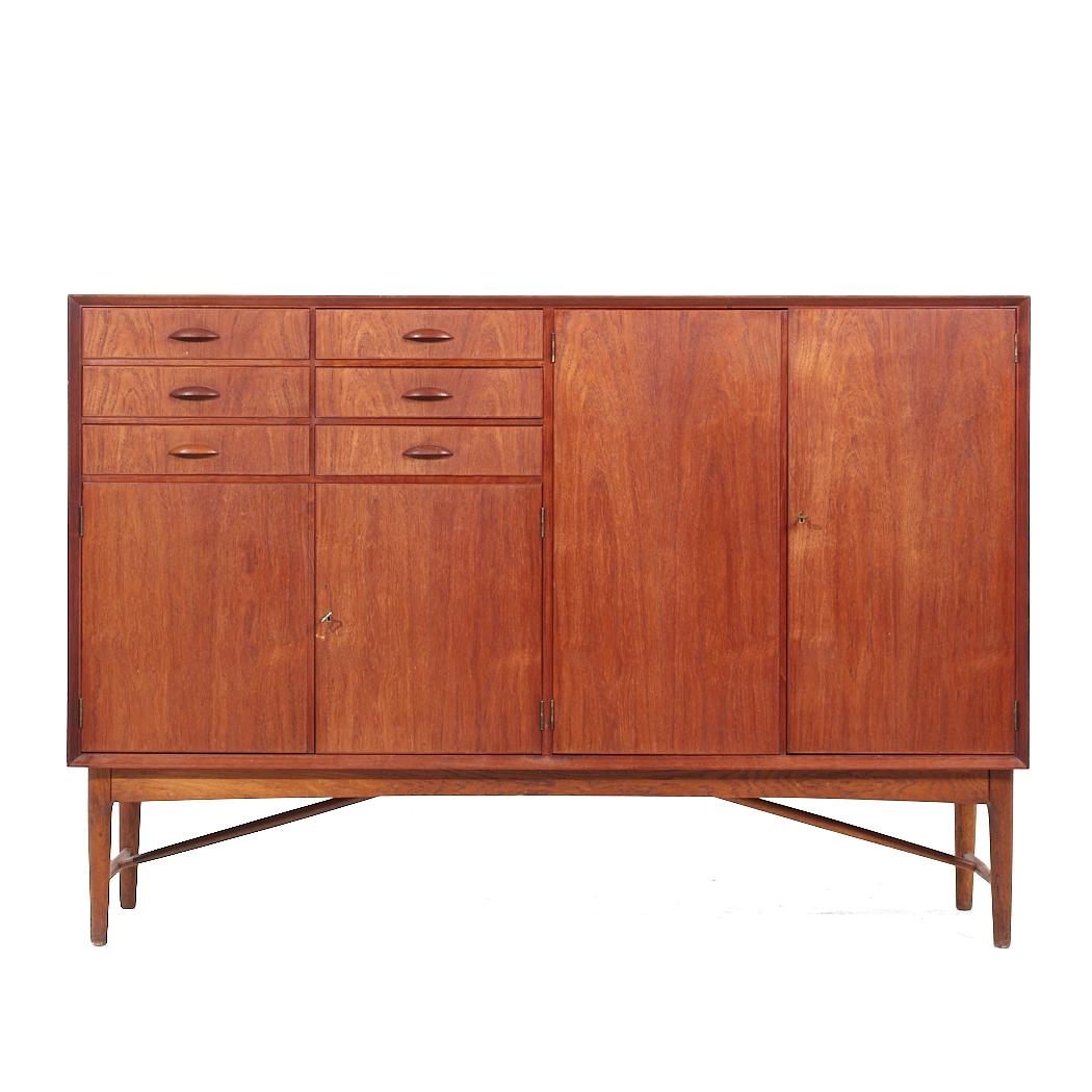 Edvard Valentinsen Mid Century Danish Teak Tall Credenza

This credenza measures: 68 wide x 17.25 deep x 46.5 inches high

All pieces of furniture can be had in what we call restored vintage condition. That means the piece is restored upon purchase