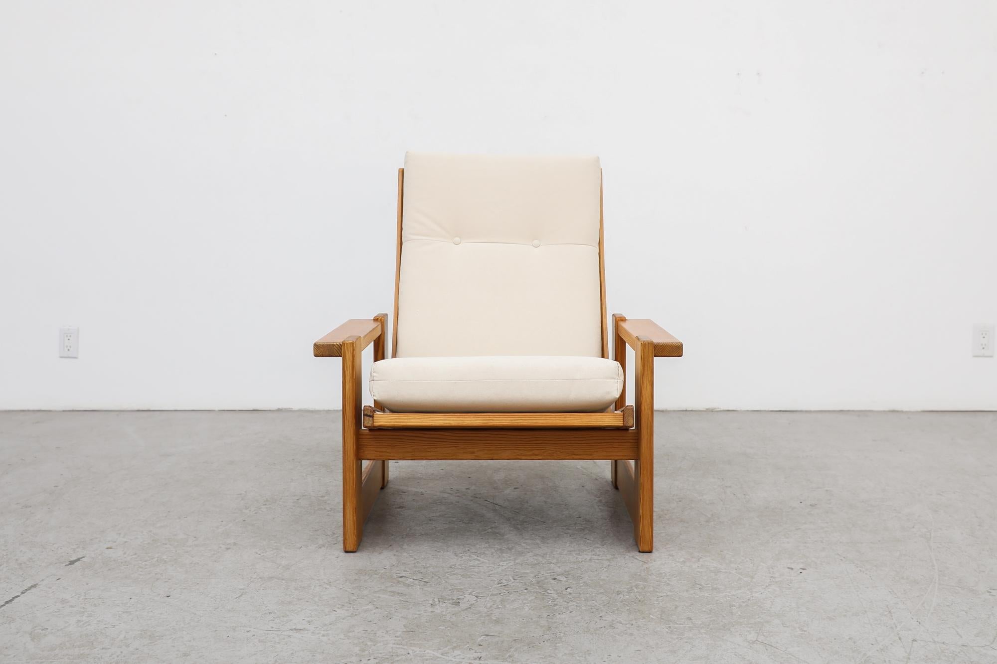 This strikingly austere, mid century, crate style lounge chair in the manner of Edvin Helseth is made from pine and has new natural canvas upholstered seating. The frame is in good original condition with wear consistent with its age and use. Other