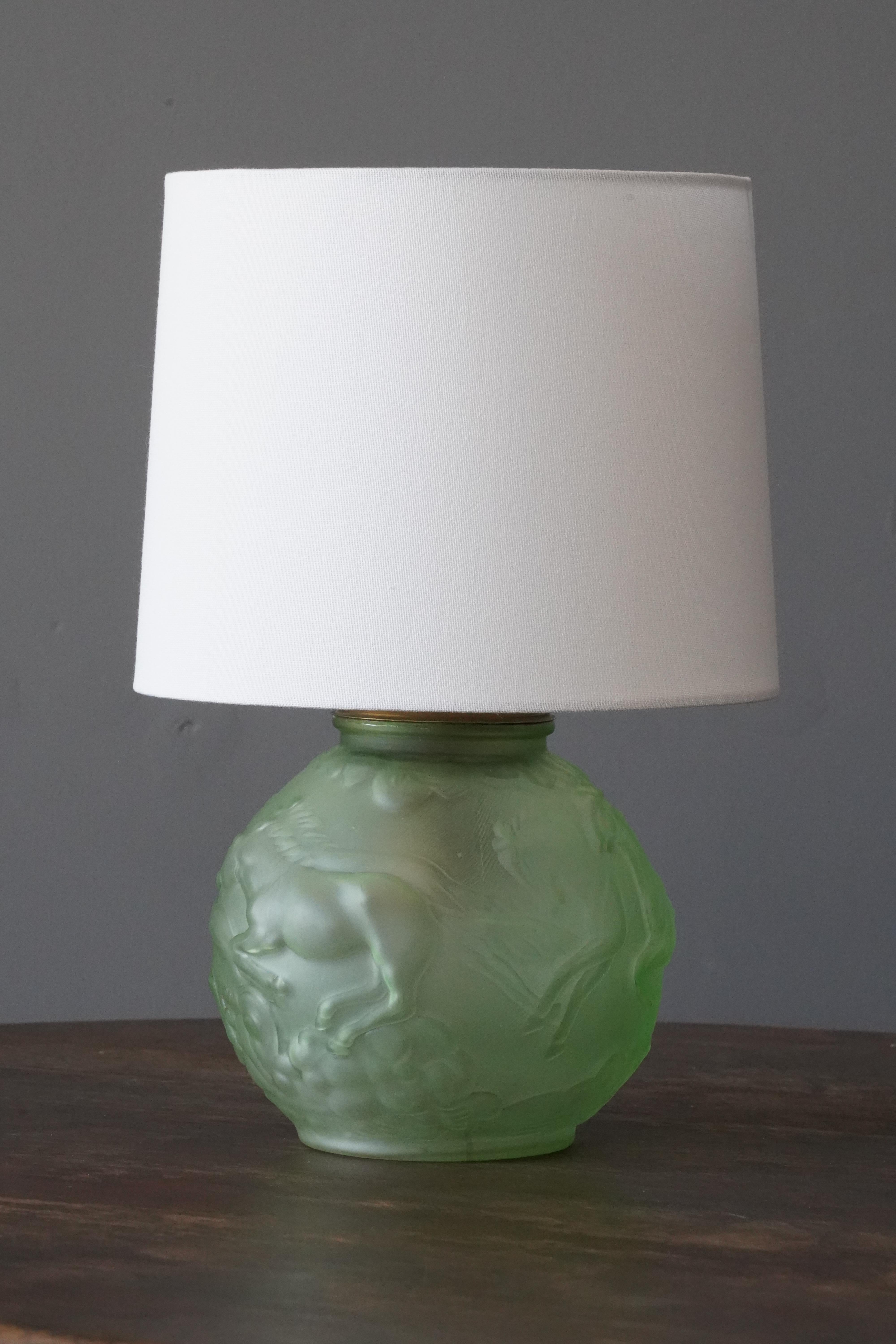 A table lamp, designed by Edvin Ollers for Elme Glasbruk, Sweden, 1930s. Features two light-sources, one being inside the glass base.

Sold without lampshade, dimensions exclude lampshade, height includes socket.
