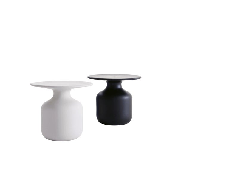 The mini bottle table by Barber and Osgerby is a Classic yet striking service table made of handcrafted ceramic, available in either white or black. Mini Bottle is created in one of the most famous Italian laboratories, a place where earth is