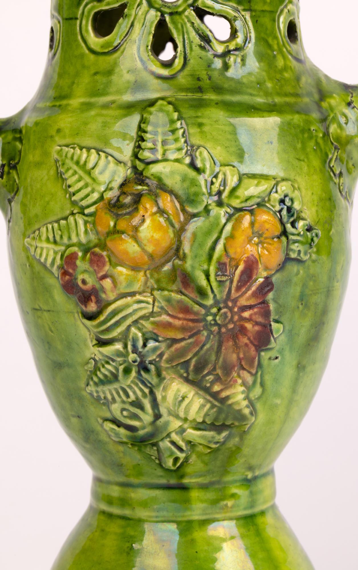A rare and unusual castle Hedingham pottery twin handled puzzle vase or jug designed by Edward Bingham (British, 1829-1914) and dating between 1864 and 1901. Inspired by medieval and Tudor wares Bingham hand produced an assortment of wares, mostly