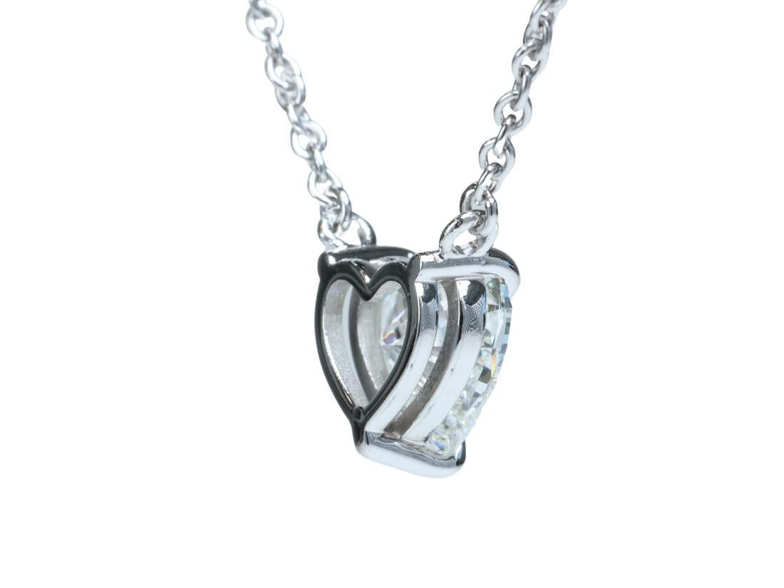 Ce nouveau collier pendentif solitaire finement réalisé présente un diamant naturel de taille brillant en cœur de 1,59 carat de couleur G et de pureté VVS2, accompagné d'un rapport GIA original. 

Le diamant est de couleur G blanc brillant et de