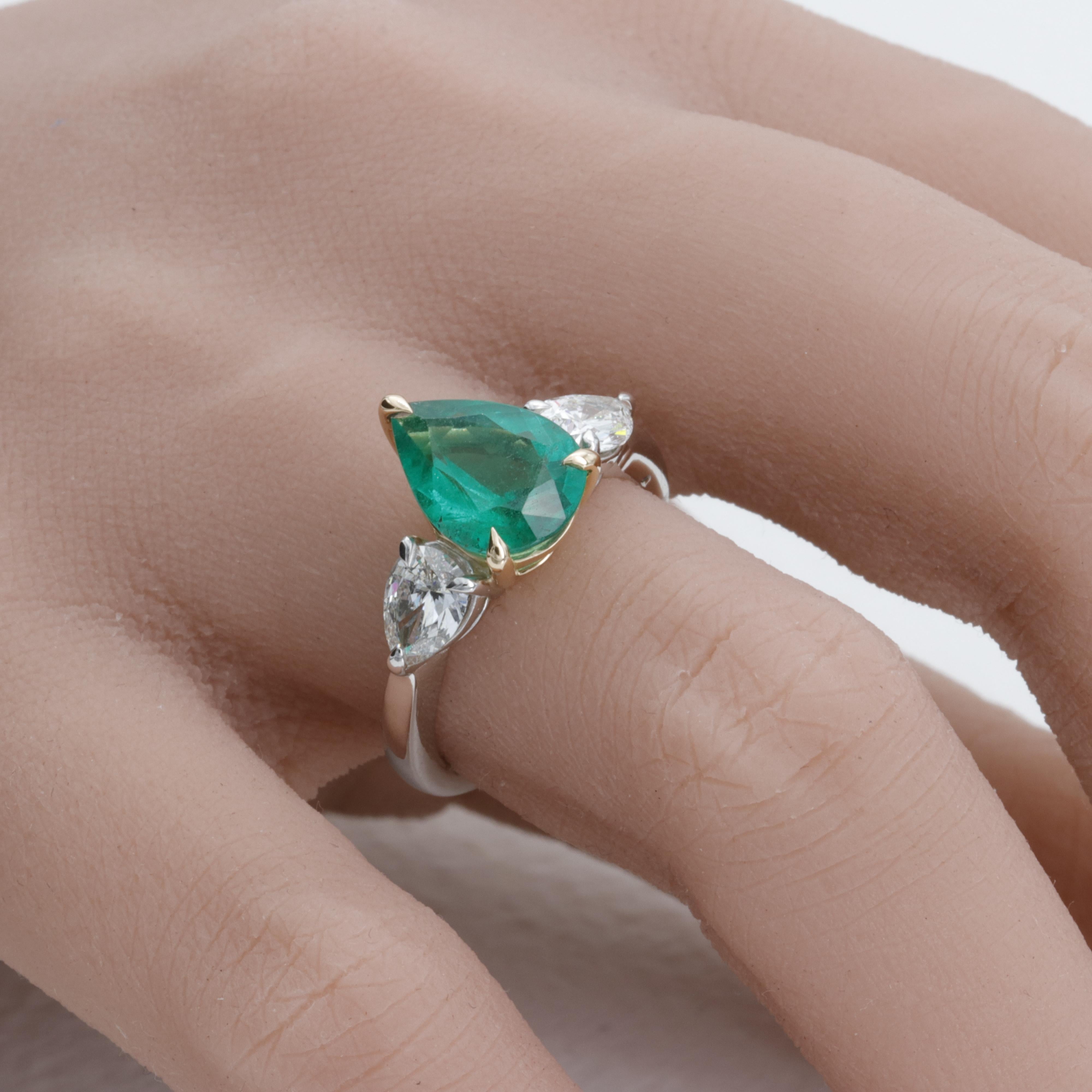 This unworn three stone ring features an exceptional pear shape emerald weighing 2.26 carats expertly set in platinum and 18 karat yellow gold and flanked by 2 excellent cut pear shape diamonds of fine quality weighing 0.97 carats. 

The emerald