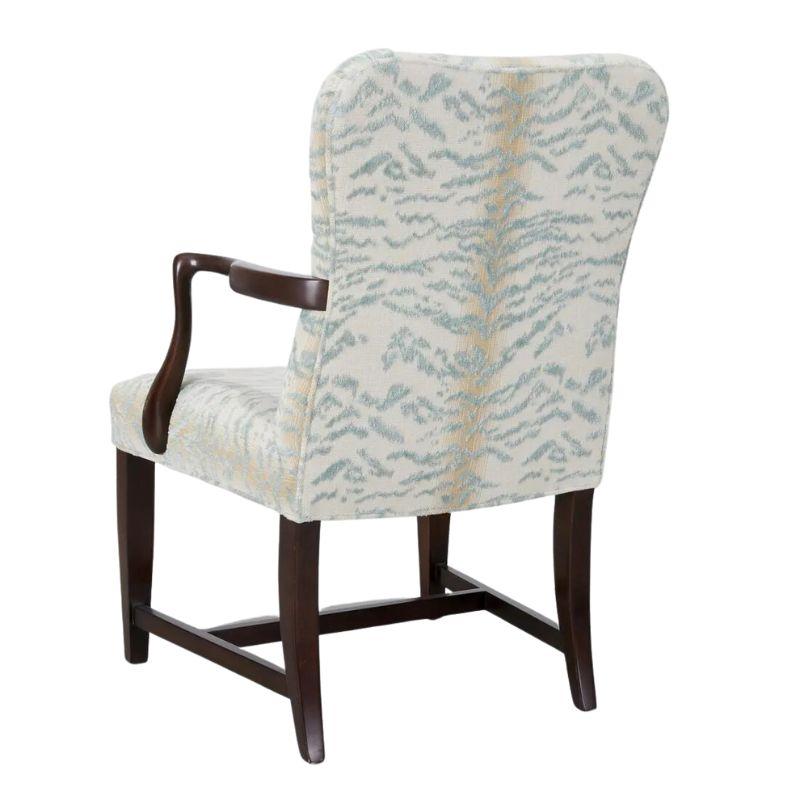 An Edward Ferrell English arm chair in Cowtan and Tout blue zebra cut velvet fabric upholstery.  Chair frame features slender dark wood arms with a graceful curve complemented by a graceful curve to the chair back and seat front.  The chair's legs