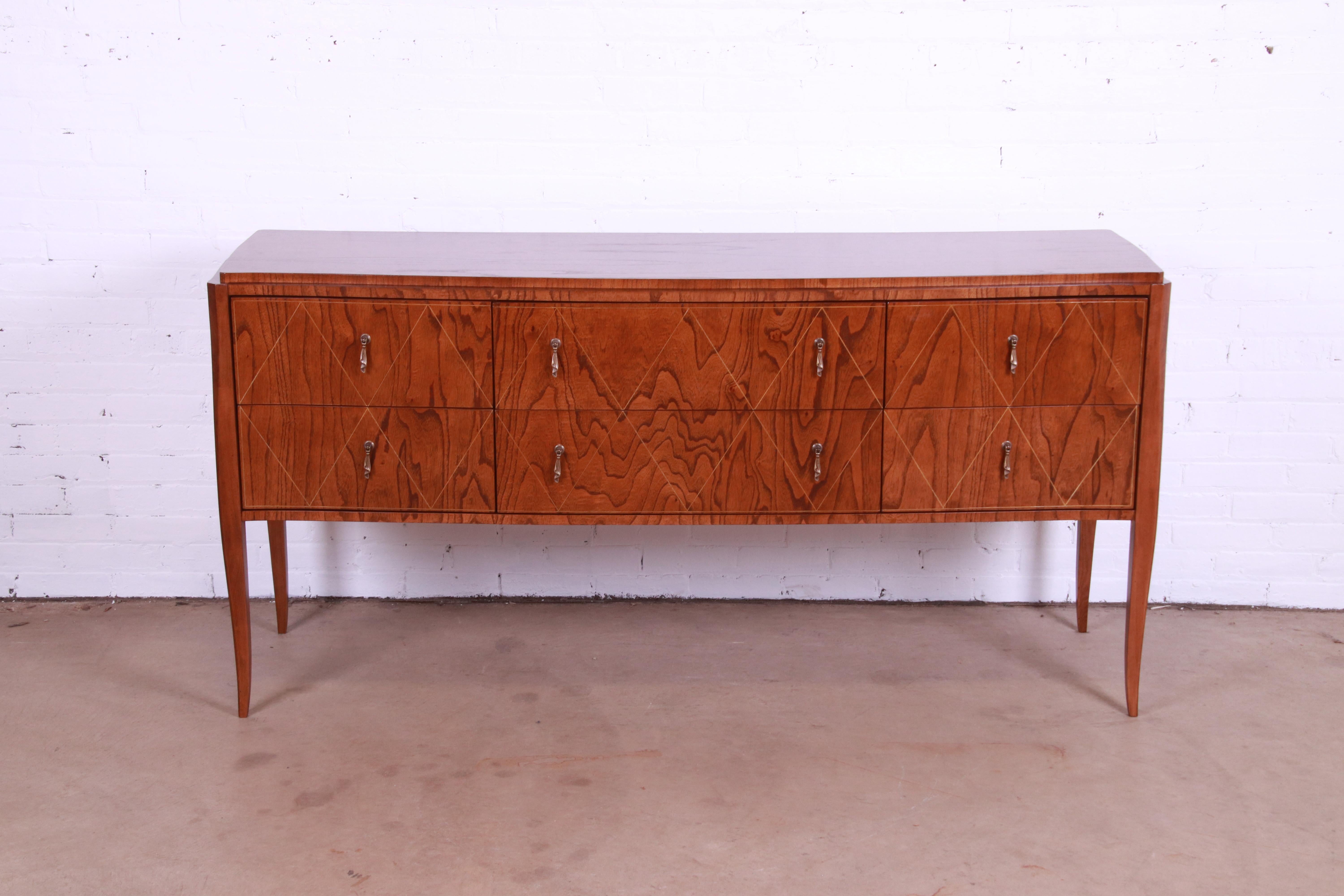 A gorgeous French Regency Louis XV style sideboard, credenza, or media cabinet

By Edward Ferrell & Lewis Mittman

USA, Circa 1990s

Figured burl wood, with diamond design inlay, and original brass hardware.

Measures: 70